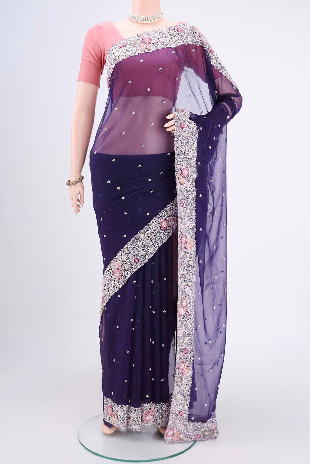 Purple Organza Silk Saree with Embroidery on the body and Embroidery Border.  displayed on a mannequin