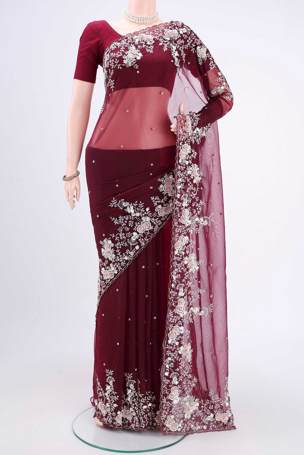Maroon Organza Silk Saree with Embroidery on the body and Embroidery Border.  displayed on a mannequin