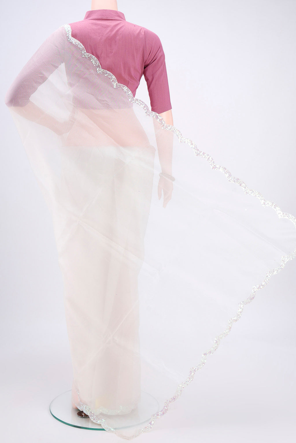 Flat view of White Organza Silk Saree with Embroidery on the body and Embroidery Border. 