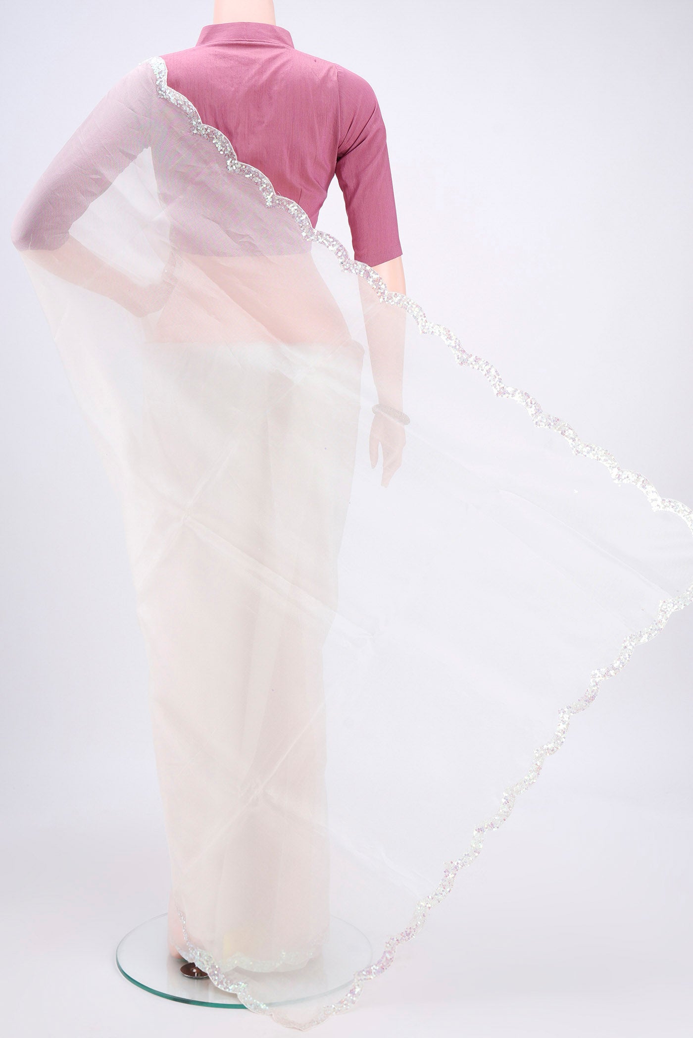 Flat view of White Organza Silk Saree with Embroidery on the body and Embroidery Border. 