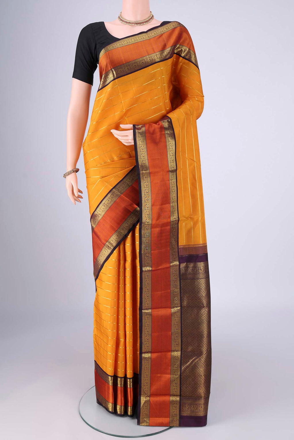 Yellow Kanjivaram Silk Saree with Veldhari on the body and Zari And Thread Border.  displayed on a mannequin