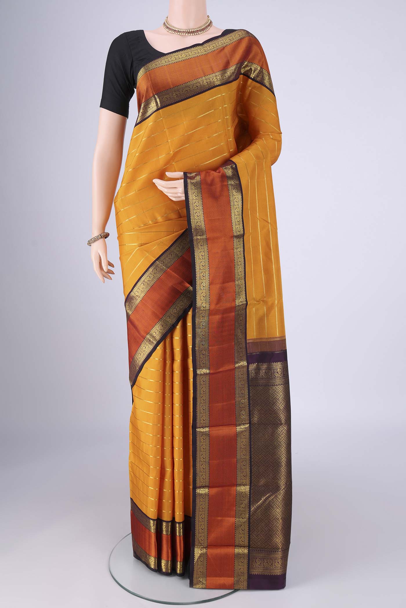 Yellow Kanjivaram Silk Saree with Veldhari on the body and Zari And Thread Border.  displayed on a mannequin