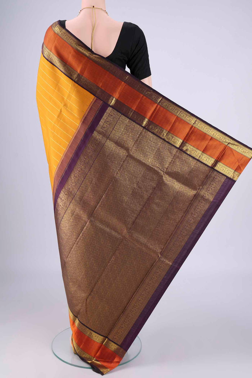 Flat view of Yellow Kanjivaram Silk Saree with Veldhari on the body and Zari And Thread Border. 