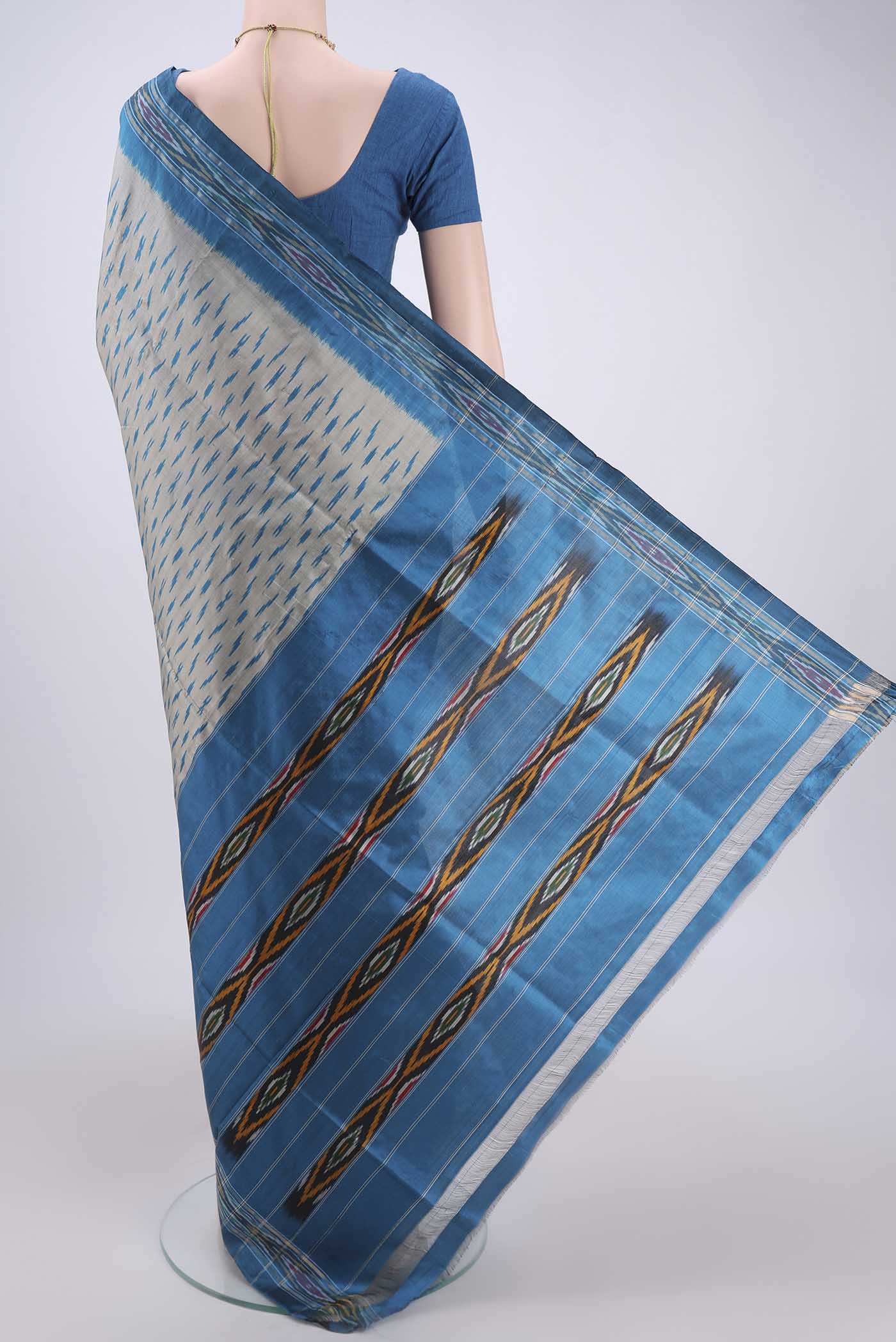 Flat view of Silver Pochampally Silk Saree with Ikat design on the body and Ikat Border. 