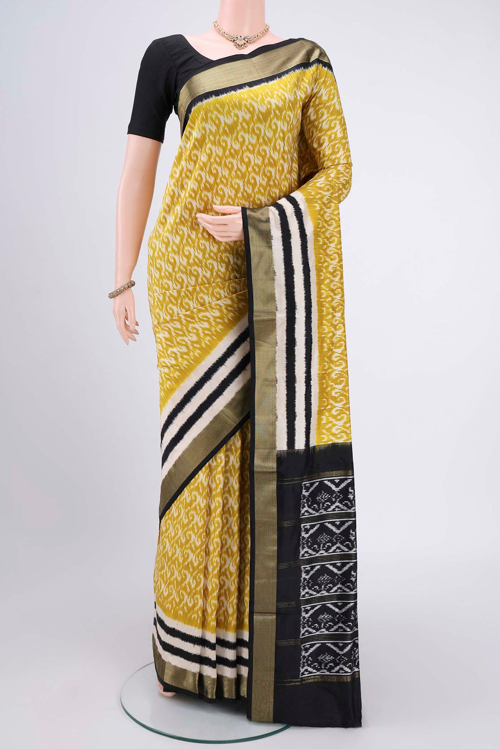 Acid Green Pochampally Silk Saree with Ikat Print on the body and Zari Border.  displayed on a mannequin