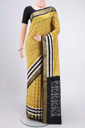 Acid Green Pochampally Silk Saree with Ikat Print on the body and Zari Border.  displayed on a mannequin