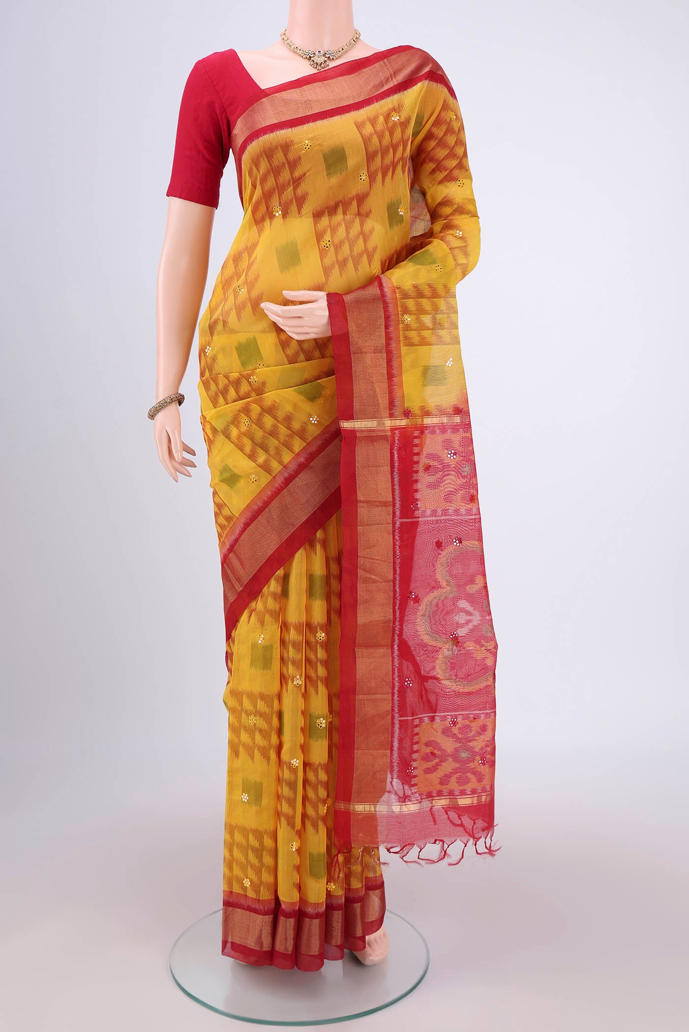 Yellow Silk Cotton Saree with Ikat design on the body and Zari Border.  displayed on a mannequin