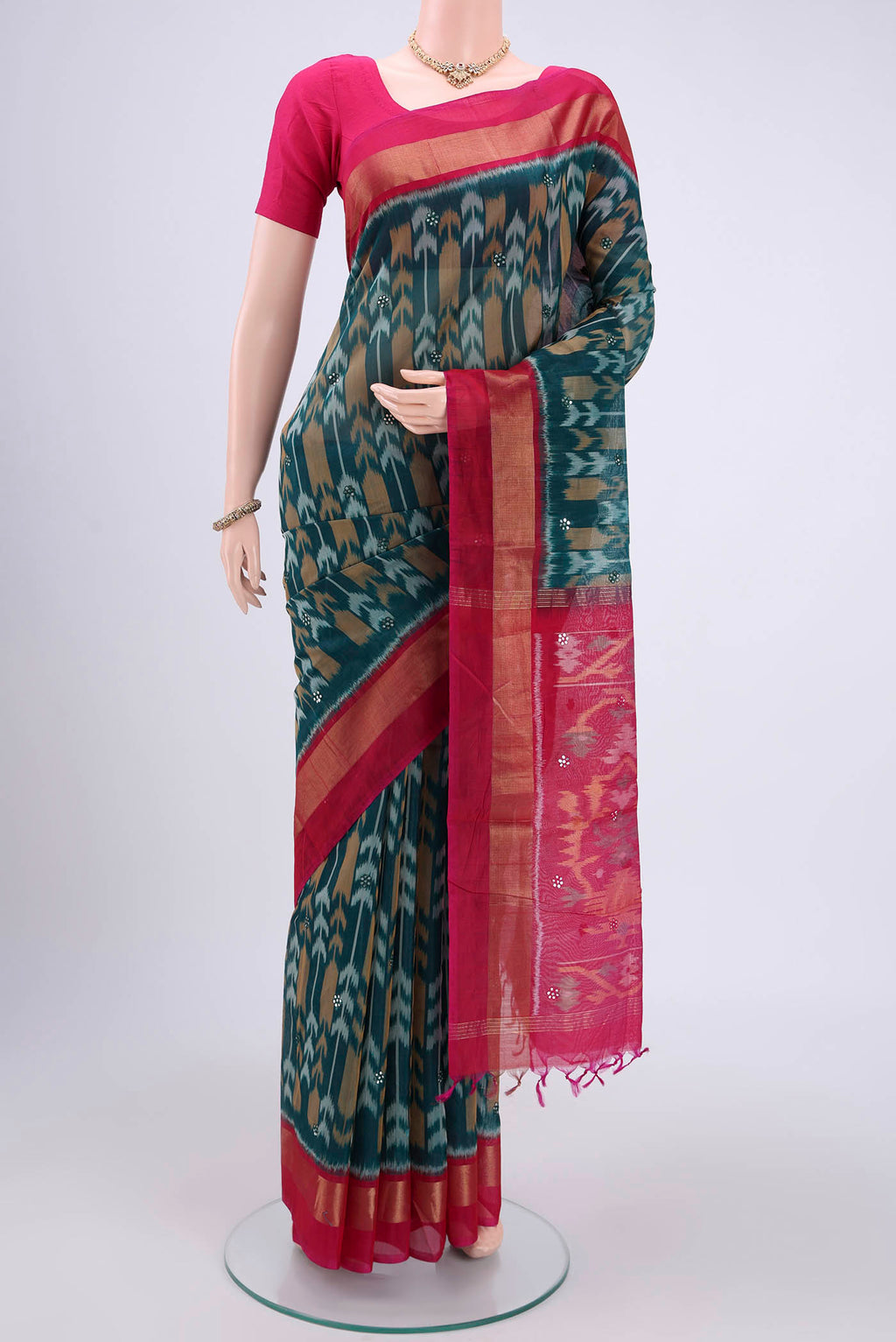 Turquoise Pochampally Silk Saree with Pure Ikat on the body and Plain Border.  displayed on a mannequin