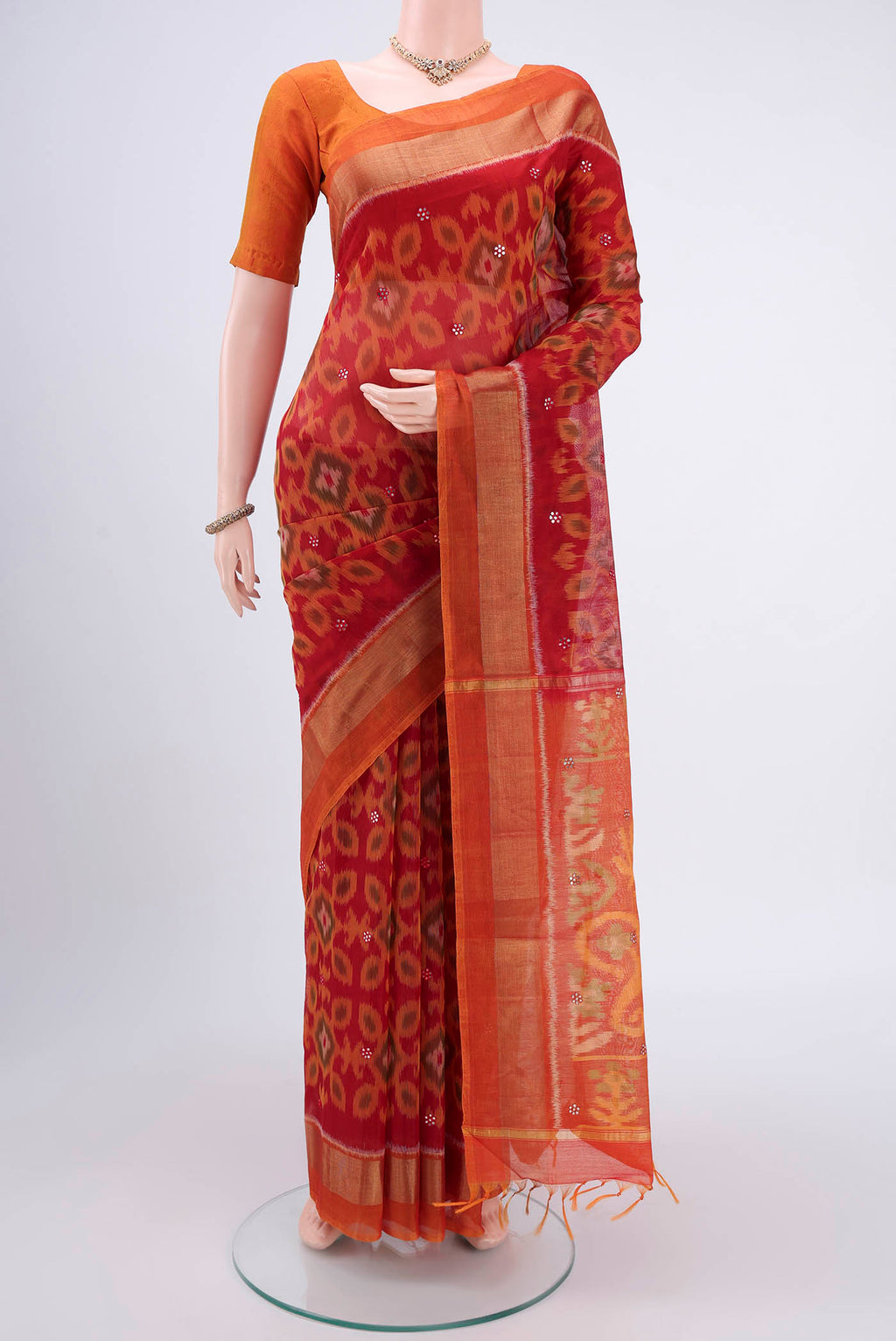 Red Pochampally Silk Saree with Pure Ikat on the body and Plain Border.  displayed on a mannequin