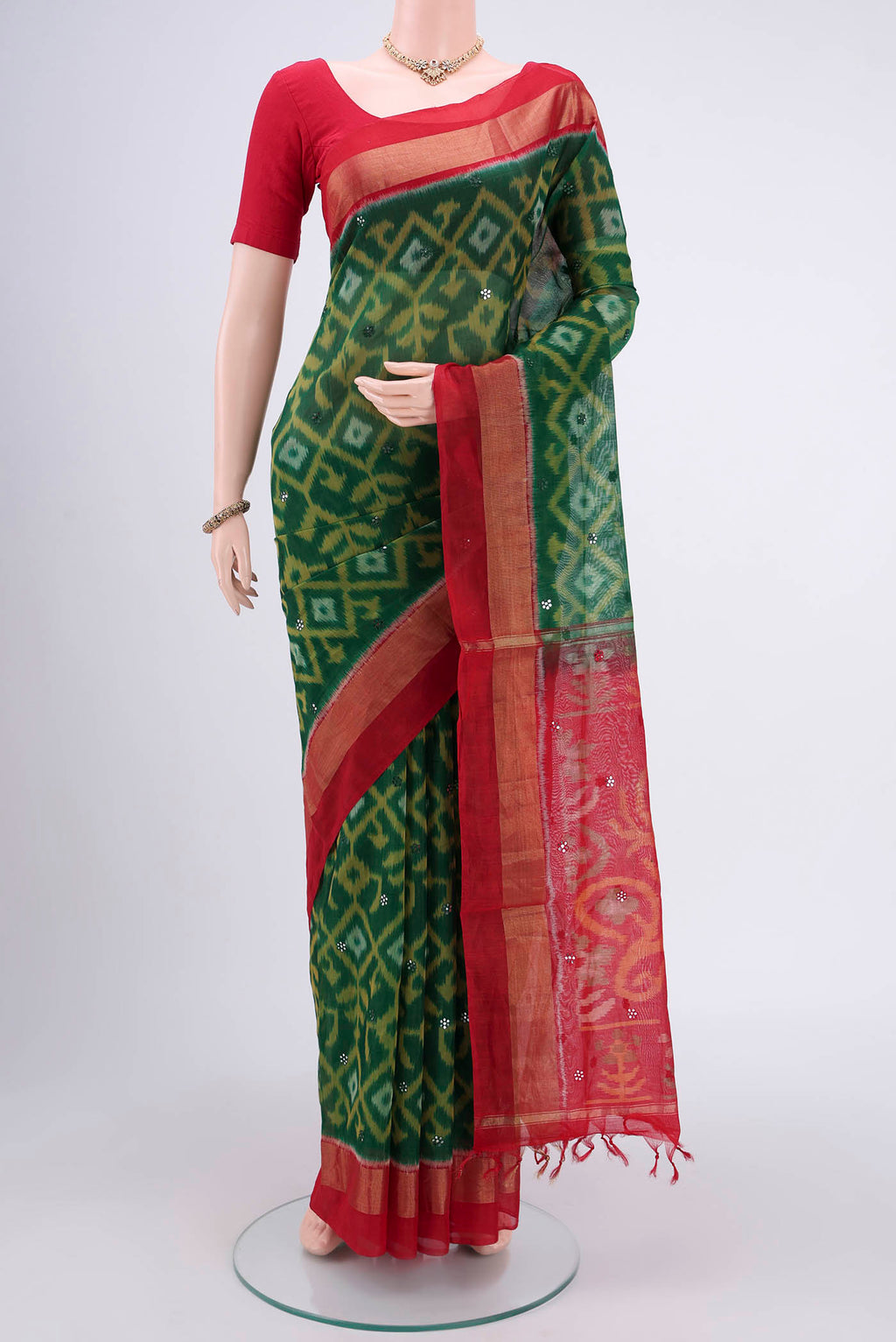 Green Kora Cotton Saree with Ikat design on the body and Zari Border.  displayed on a mannequin