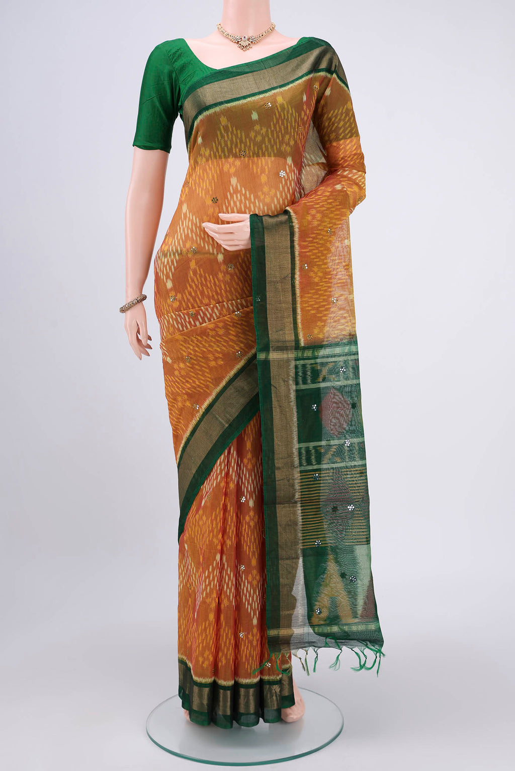 Green Pochampally Silk Saree with Pure Ikat on the body and Plain Border.  displayed on a mannequin