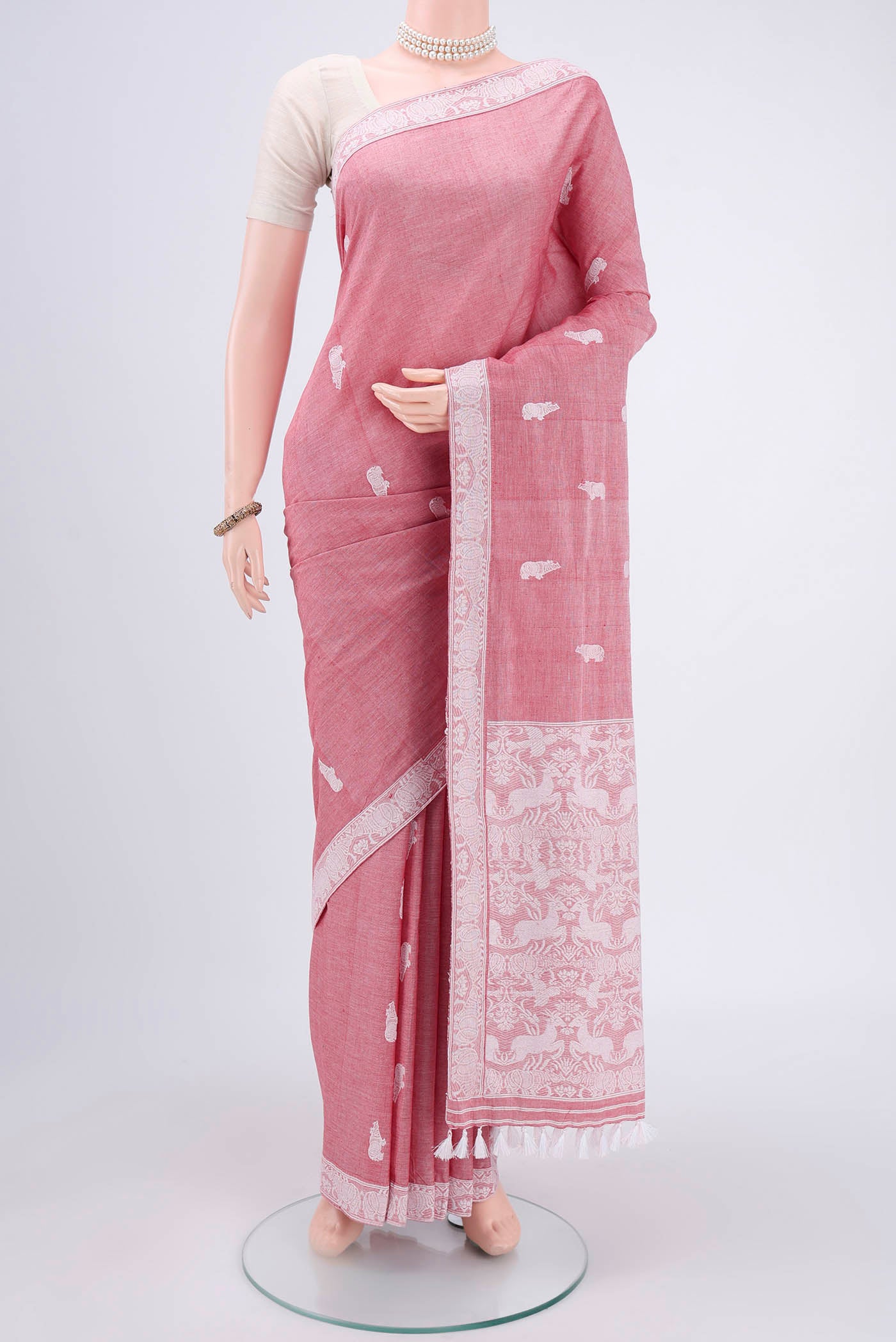 Pink Assam Cotton Saree with Thread Butta on the body and Plain Border.  displayed on a mannequin