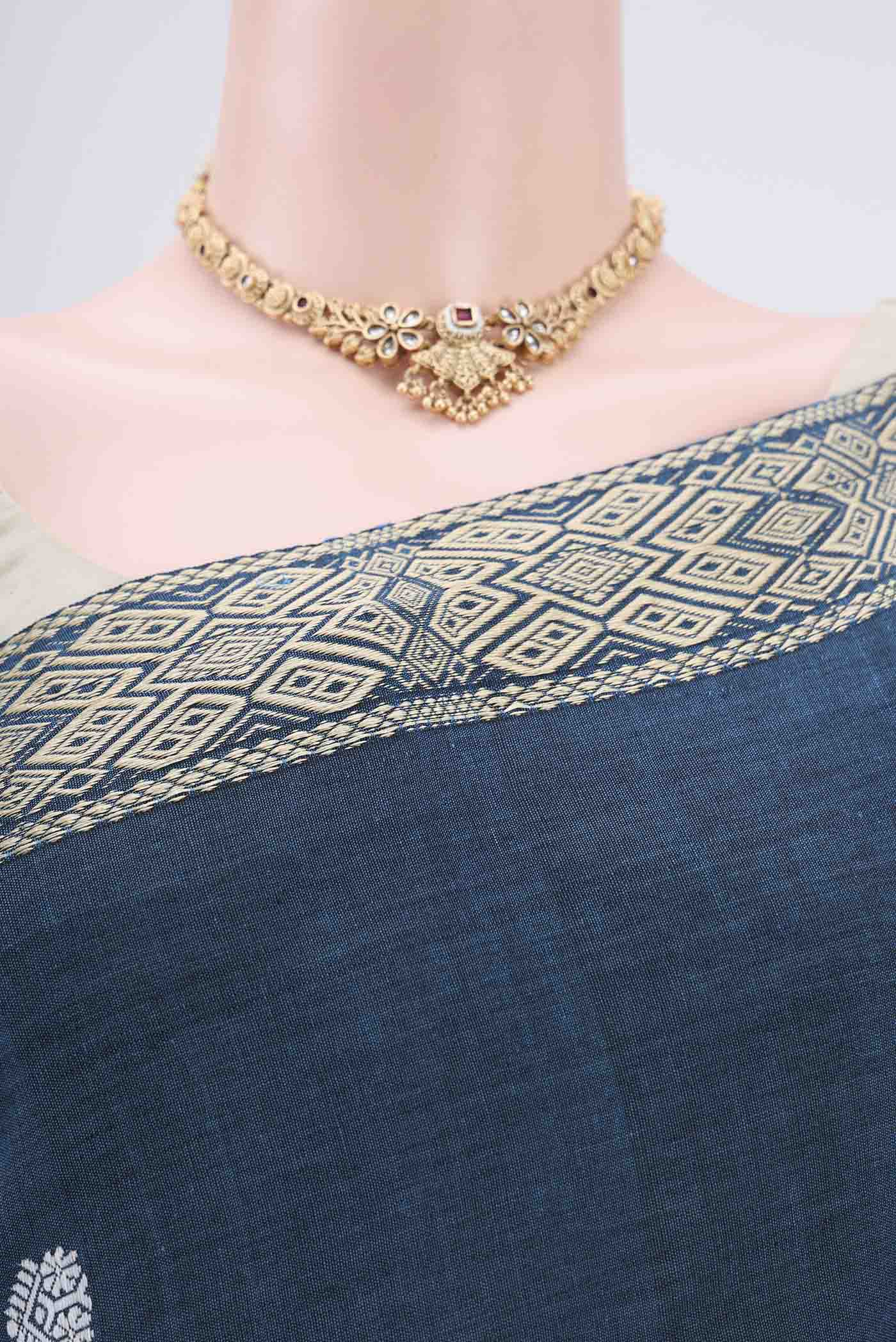 Border image of Turquoise Assam Cotton Saree with Thread Butta on the body and Plain Border. 