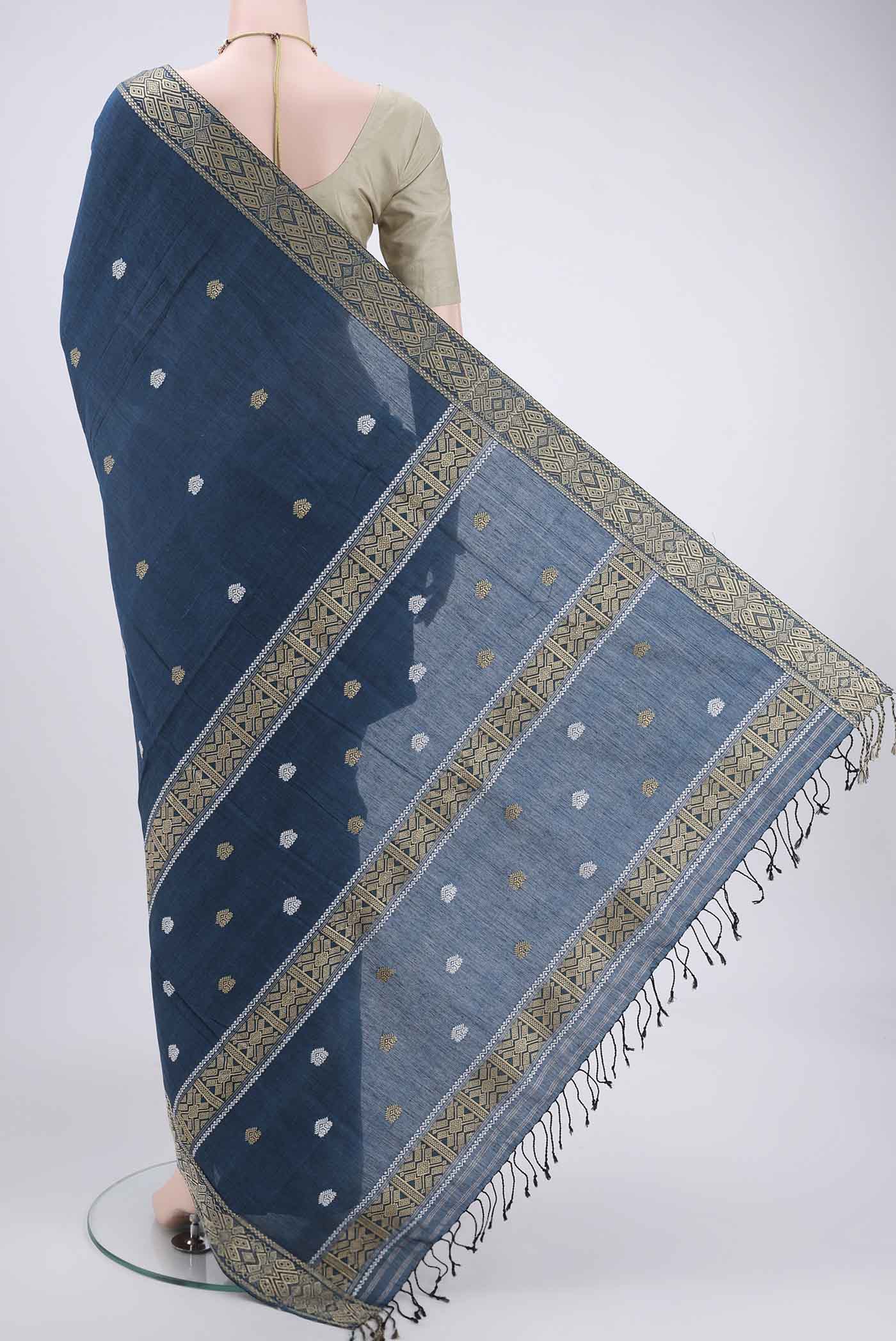 Flat view of Turquoise Assam Cotton Saree with Thread Butta on the body and Plain Border. 