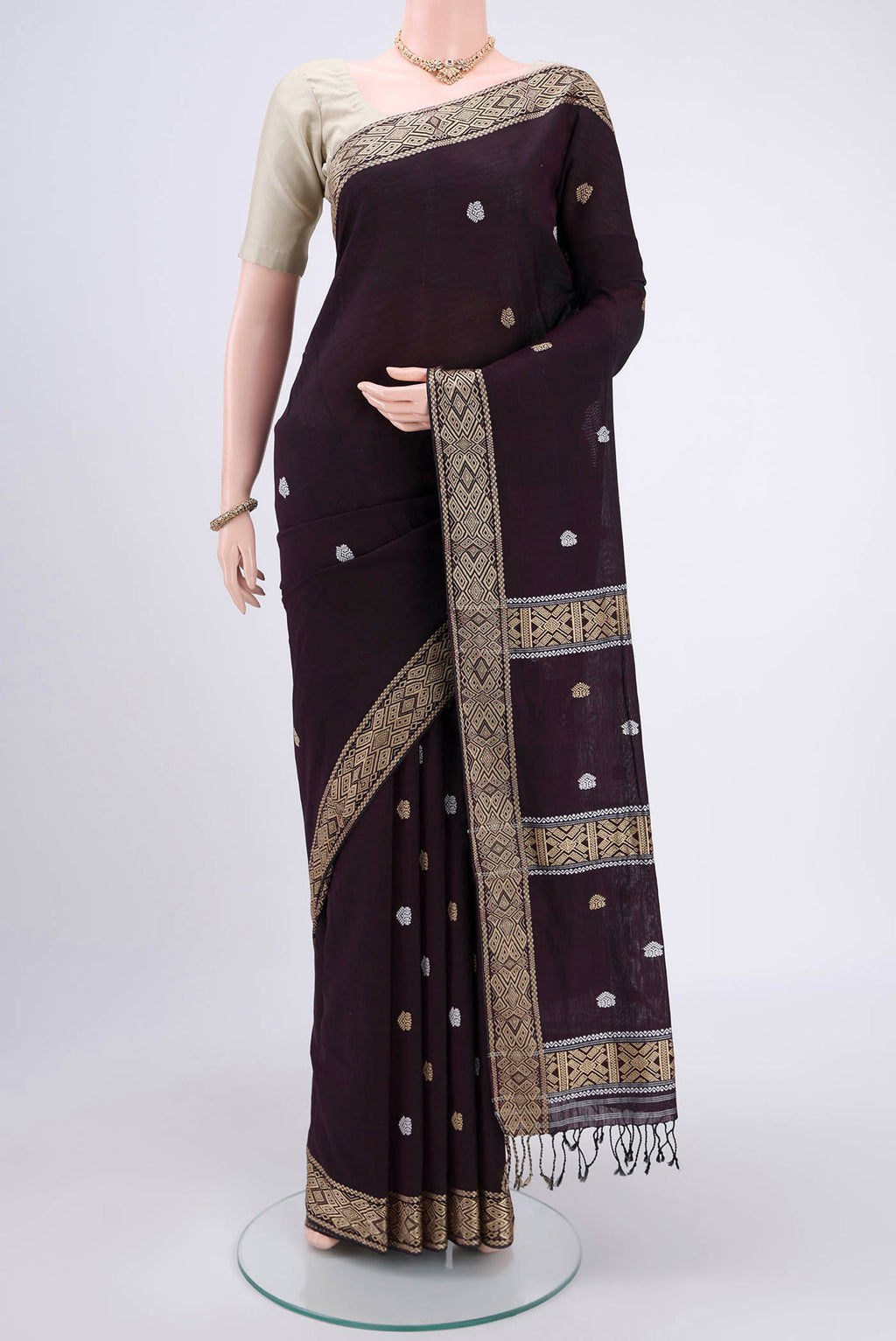 Coffee Brown Assam Cotton Saree with Thread Butta on the body and Plain Border.  displayed on a mannequin