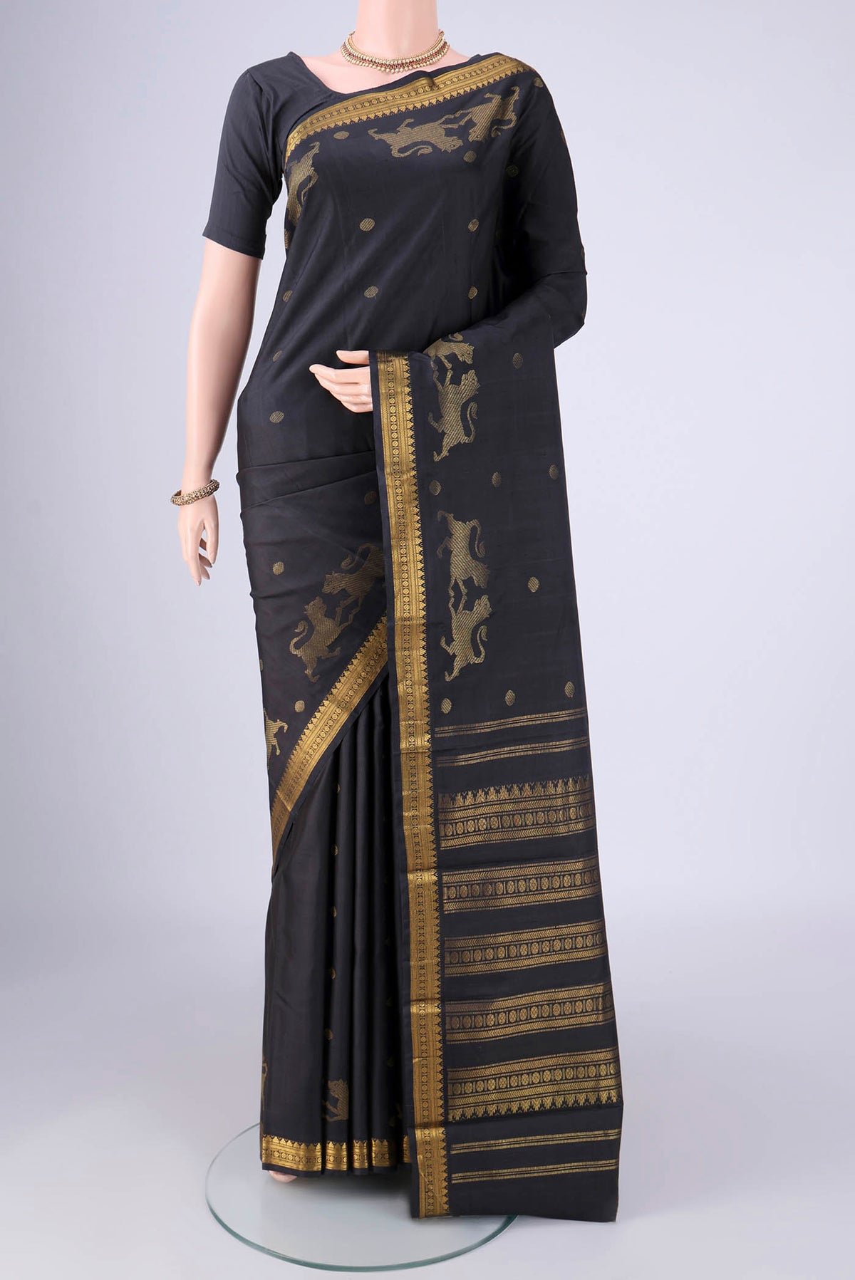 Black Kanjivaram Silk Saree with Zari Butta on the body and Zari Border.  displayed on a mannequin