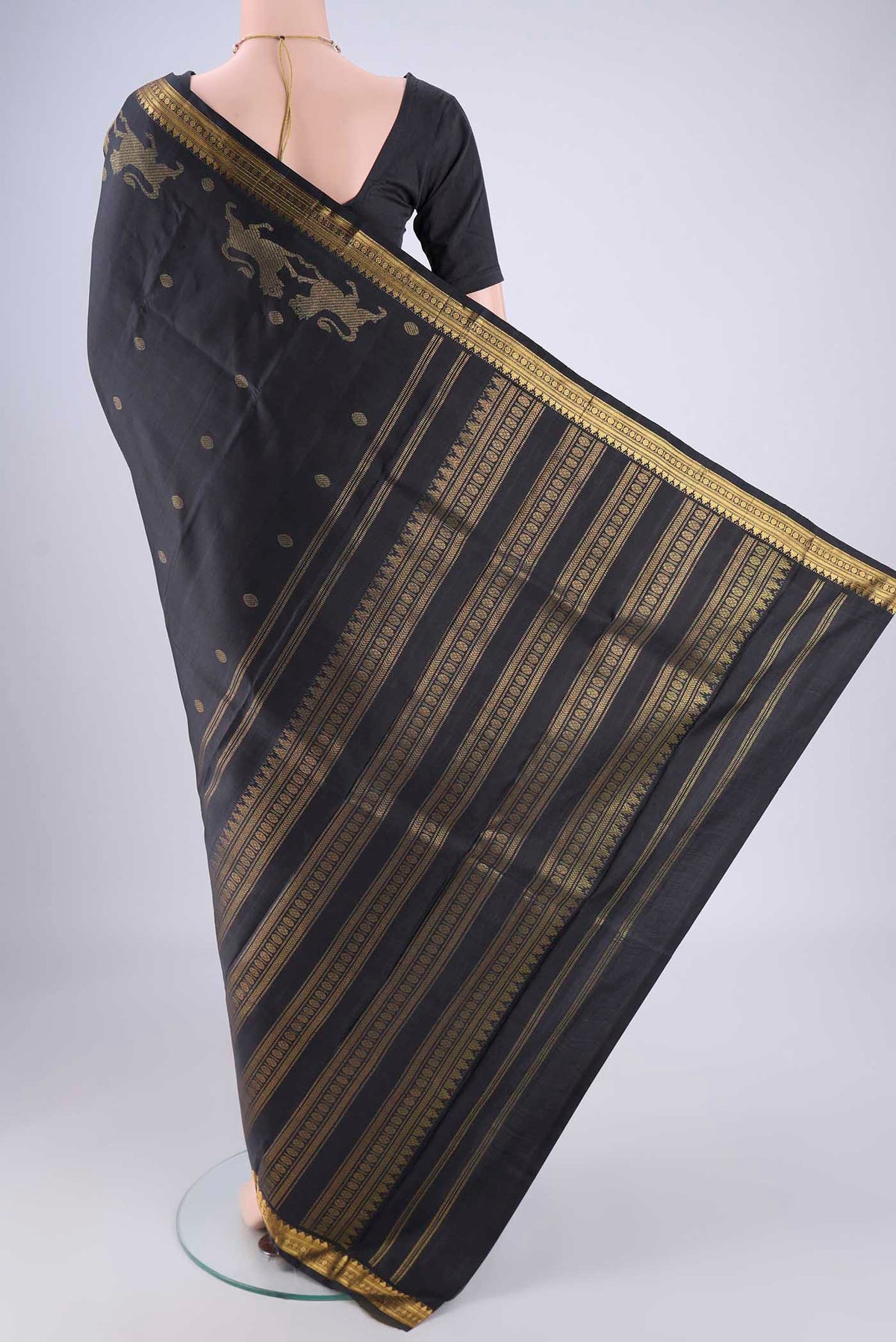 Flat view of Black Kanjivaram Silk Saree with Zari Butta on the body and Zari Border. 