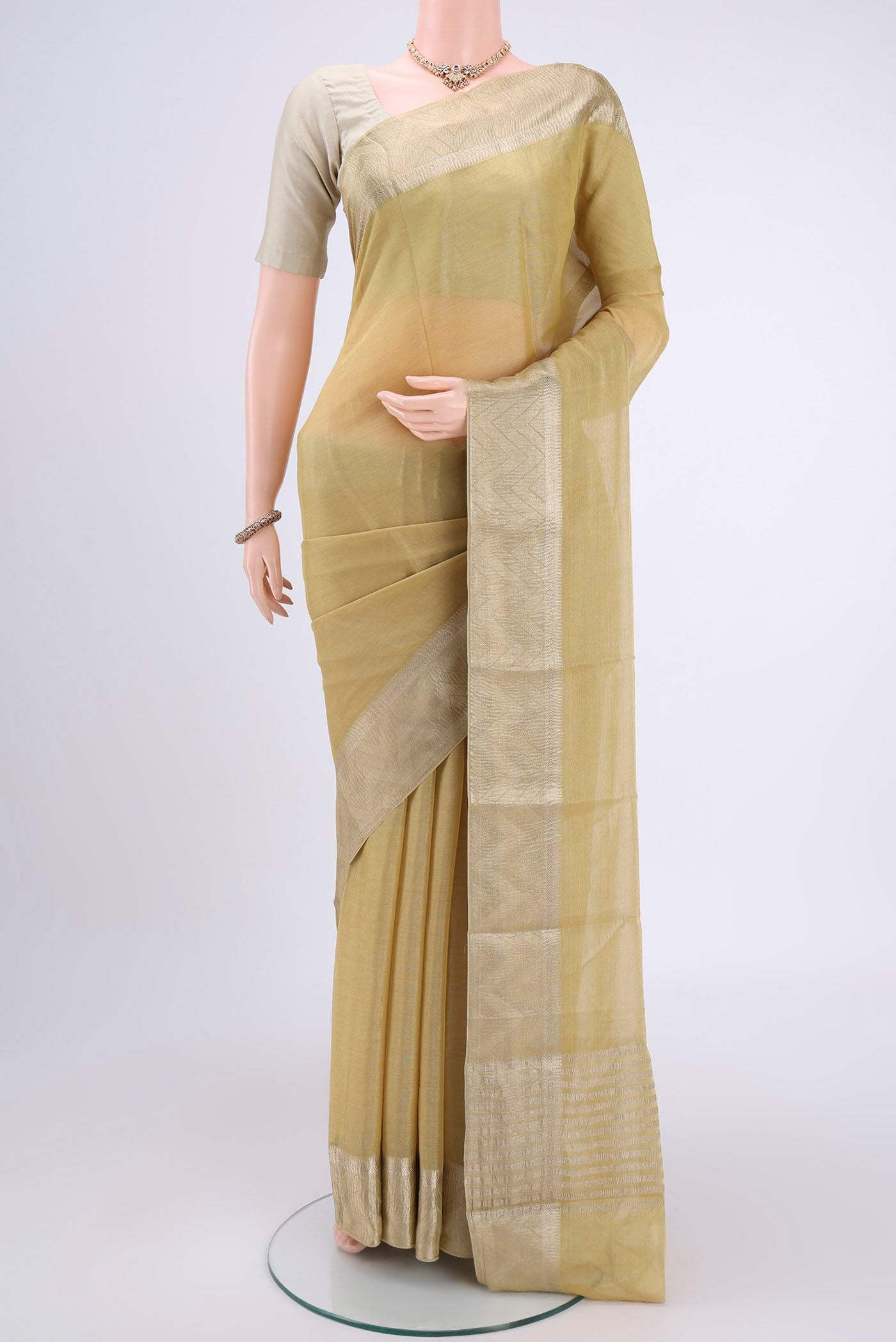 Yellow Mysore Crepe Saree with Fancy on the body and Zari Border.  displayed on a mannequin