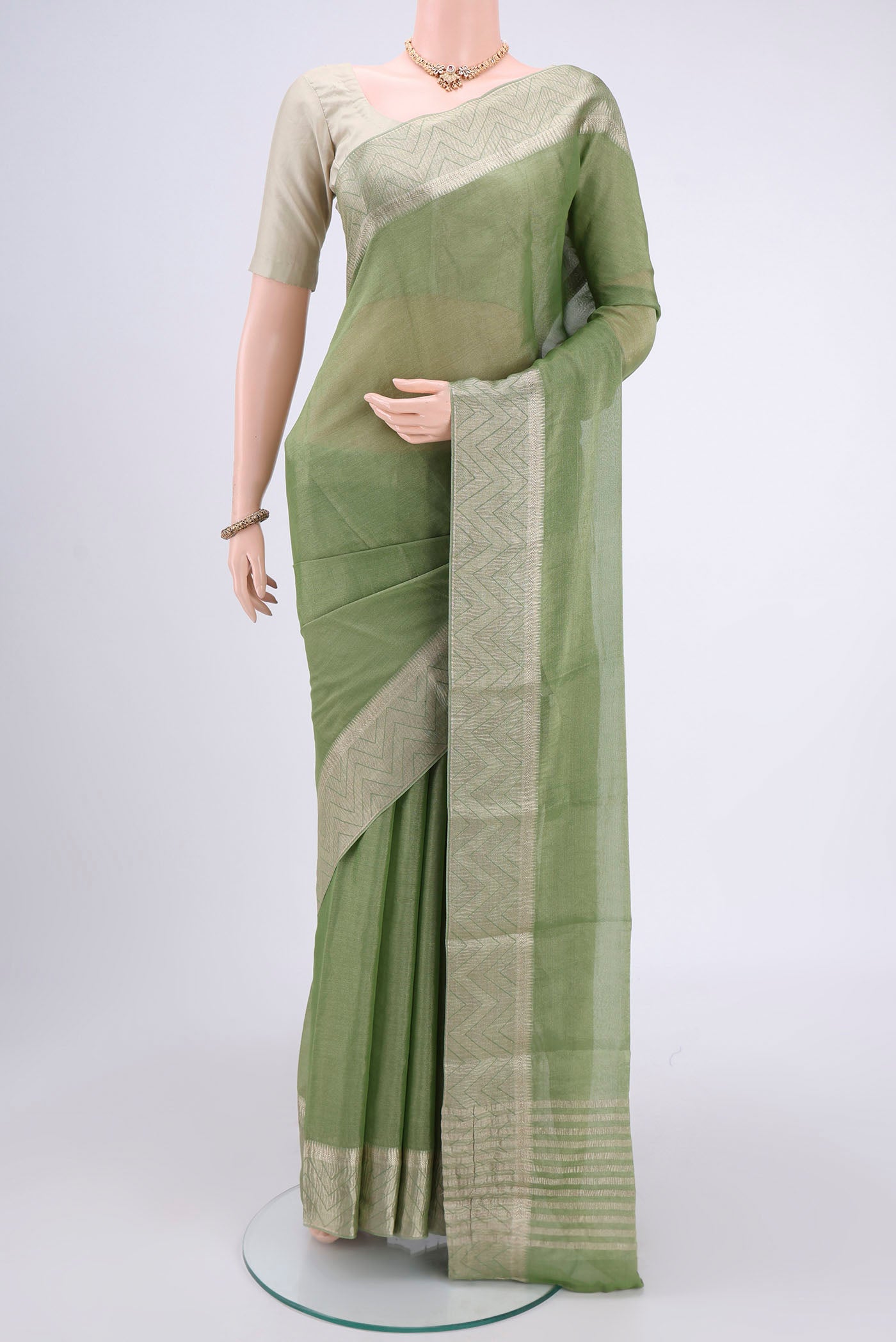 Light Green Mysore Crepe Saree with Fancy on the body and Zari Border.  displayed on a mannequin