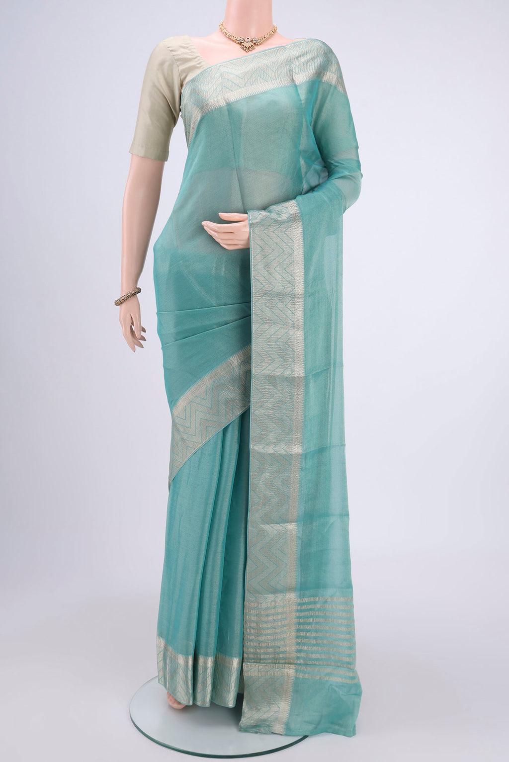 Sky Blue Mysore Crepe Saree with Fancy on the body and Zari Border.  displayed on a mannequin