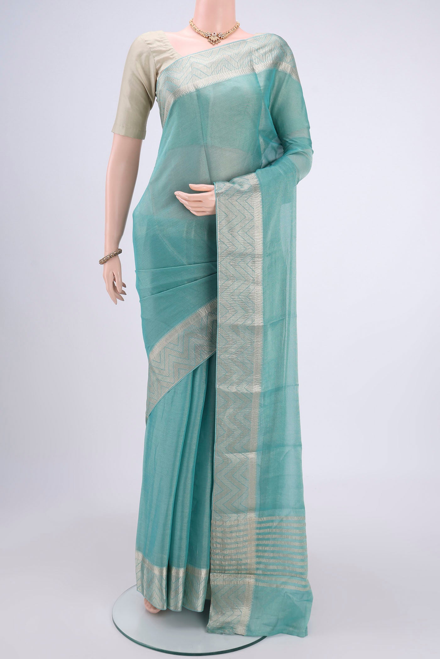 Sky Blue Mysore Crepe Saree with Fancy on the body and Zari Border.  displayed on a mannequin