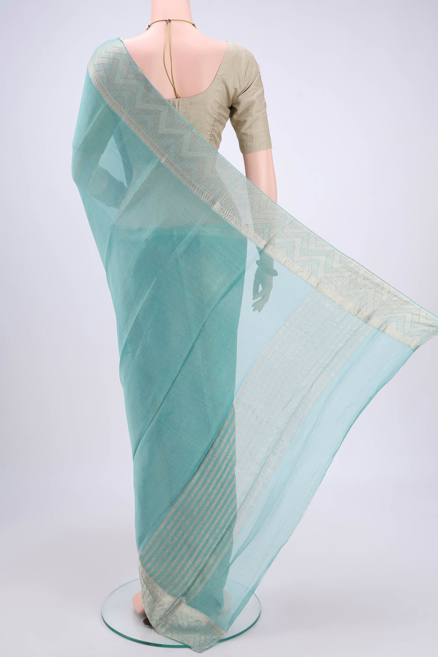 Flat view of Sky Blue Mysore Crepe Saree with Fancy on the body and Zari Border. 