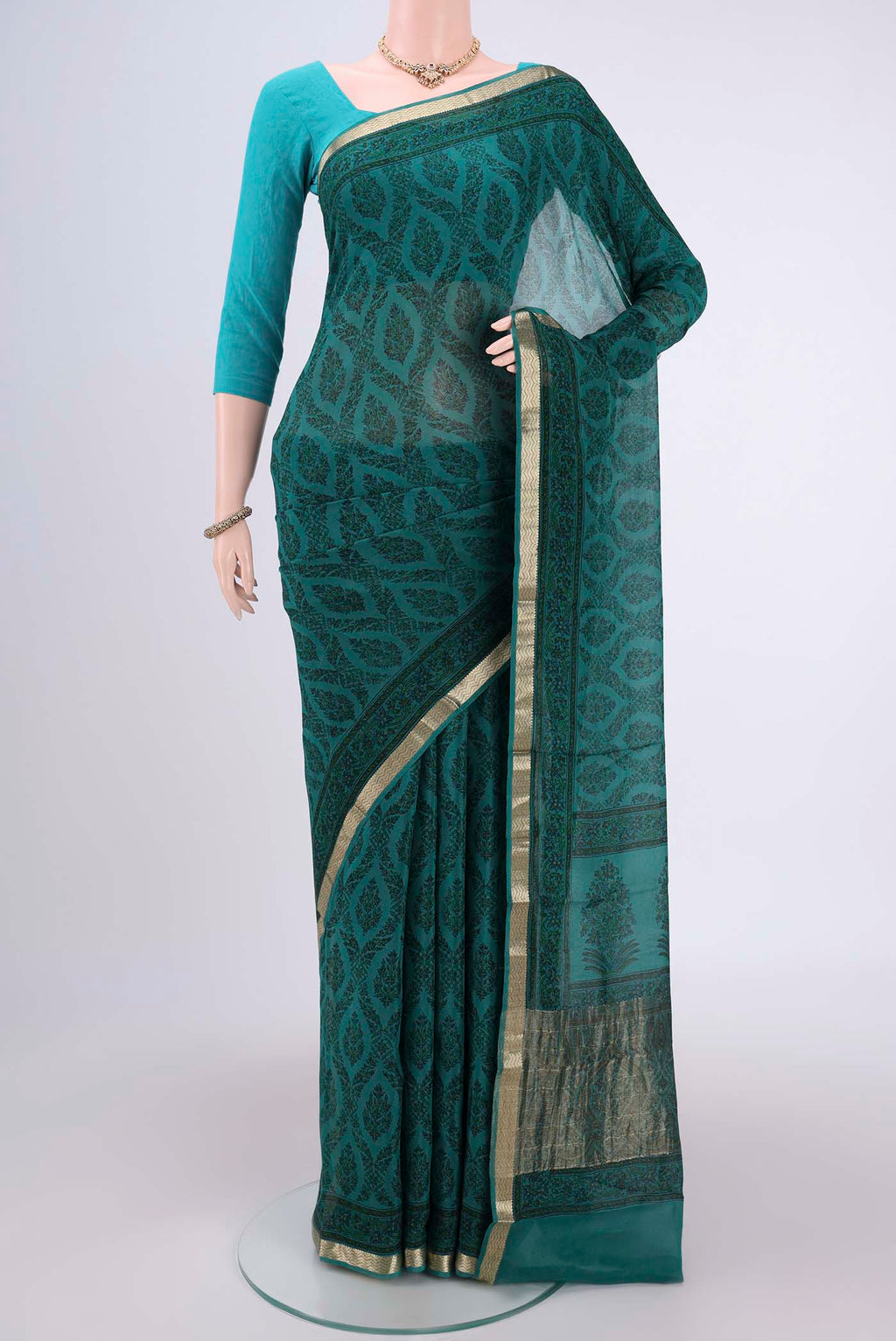 Turquoise Mysore Crepe Saree with Floral Print on the body and Zari Border.  displayed on a mannequin