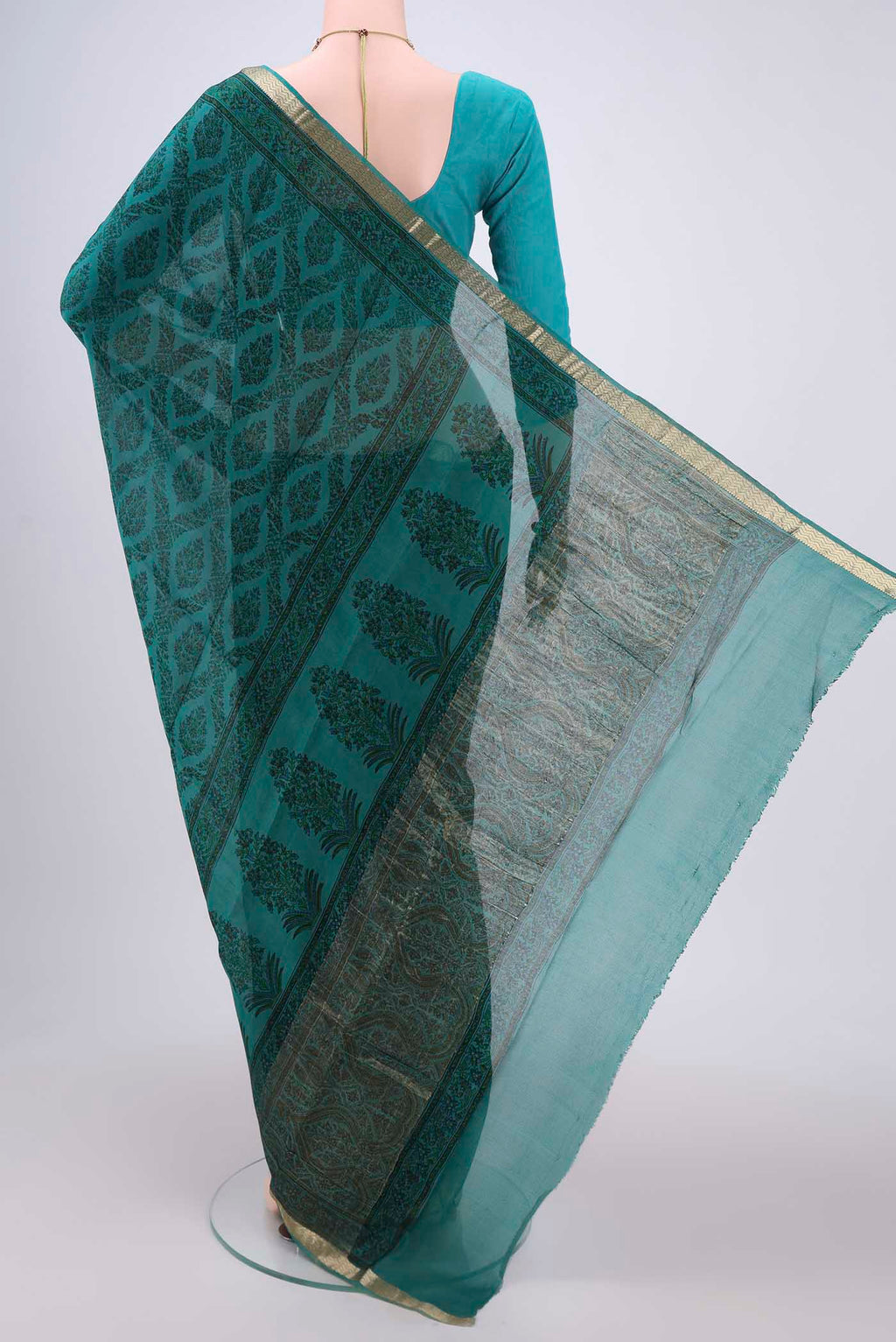 Flat view of Turquoise Mysore Crepe Saree with Floral Print on the body and Zari Border. 