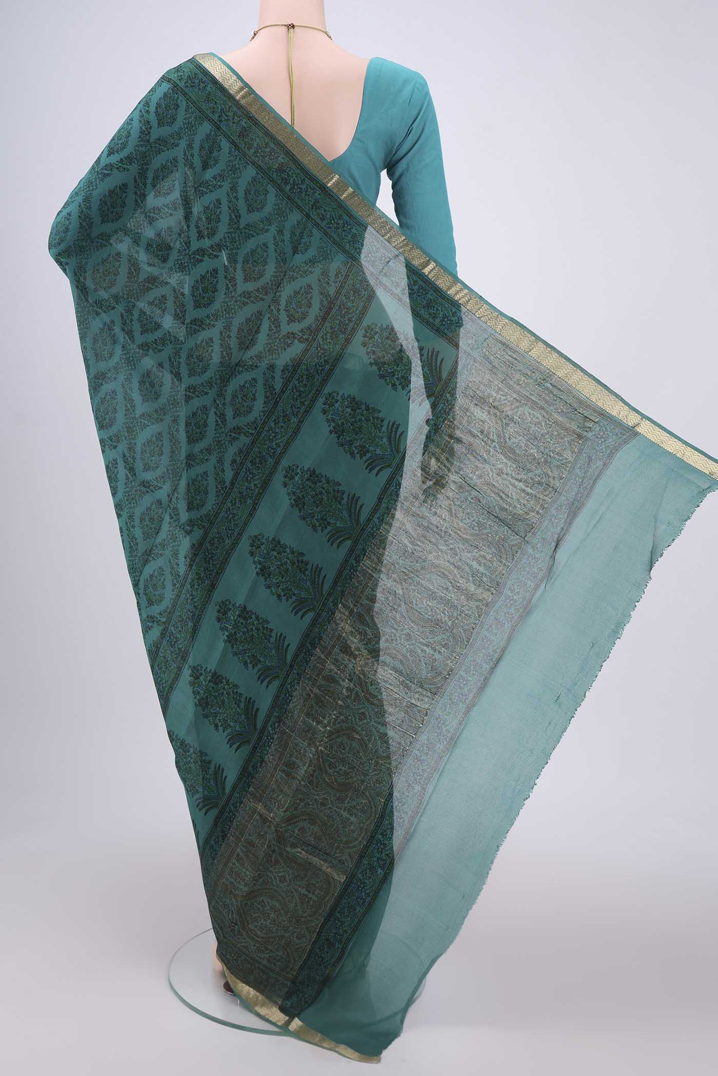 Flat view of Turquoise Mysore Crepe Saree with Floral Print on the body and Zari Border. 