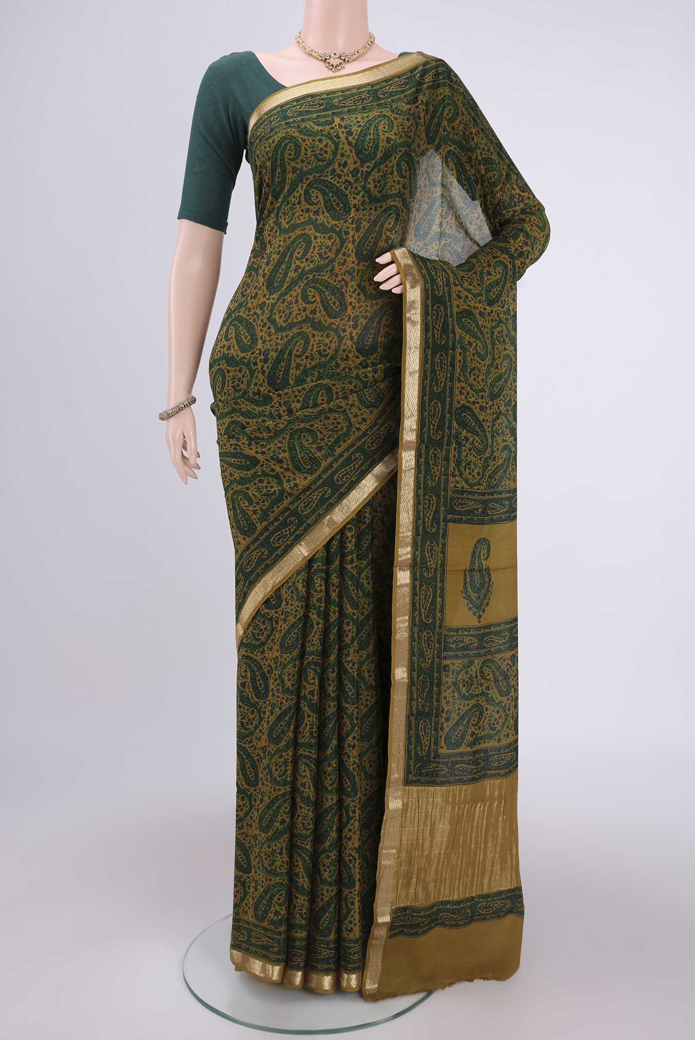 Green Mysore Crepe Saree with Floral Print on the body and Zari Border.  displayed on a mannequin