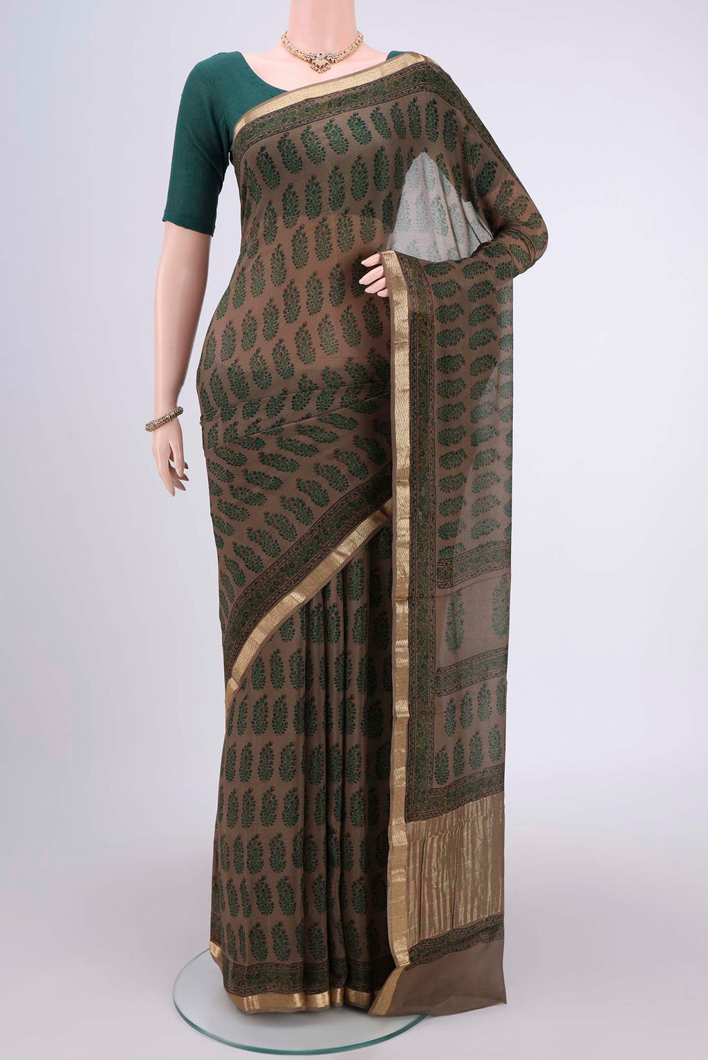 Brown Mysore Crepe Saree with Floral Print on the body and Zari Border.  displayed on a mannequin