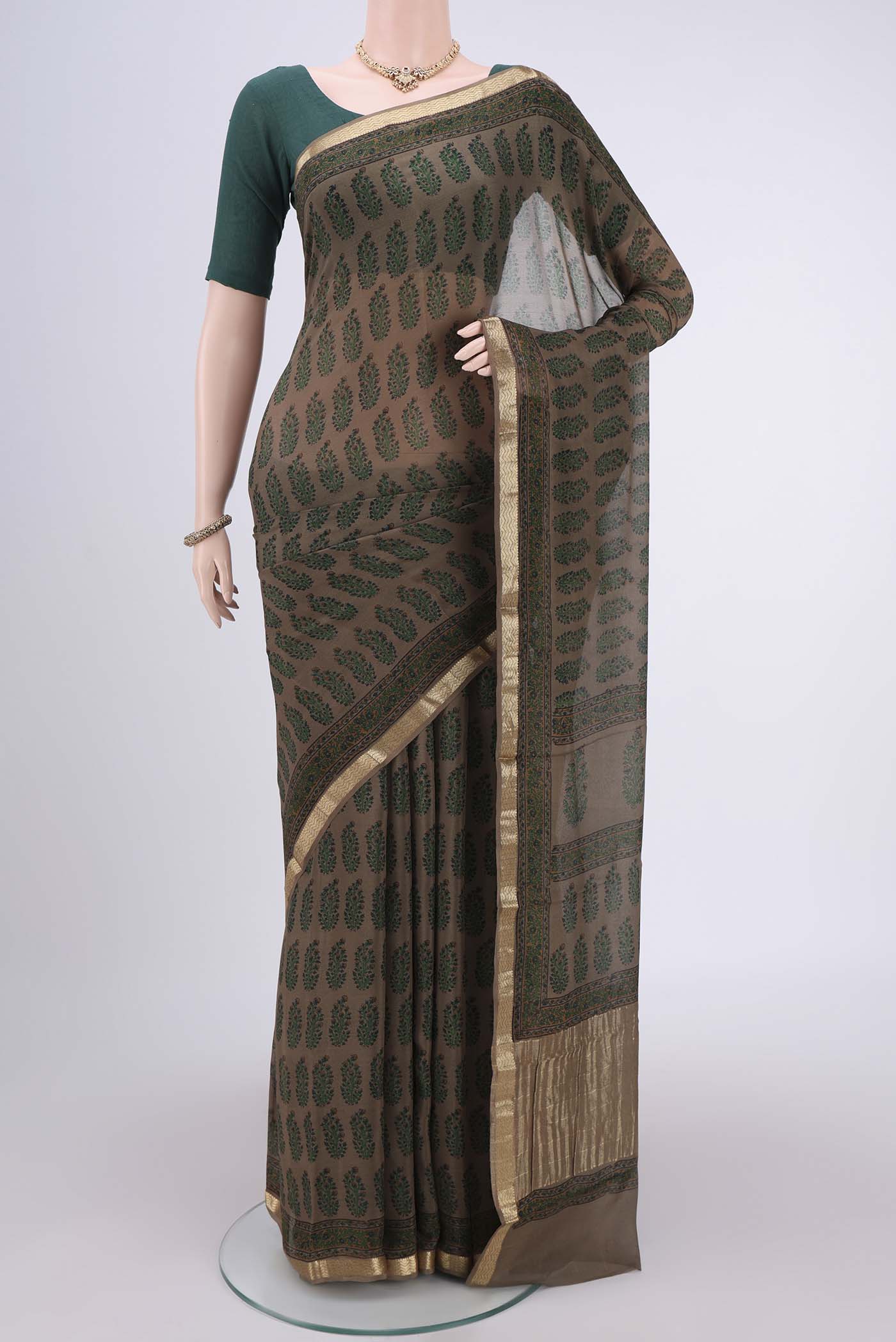 Brown Mysore Crepe Saree with Floral Print on the body and Zari Border.  displayed on a mannequin