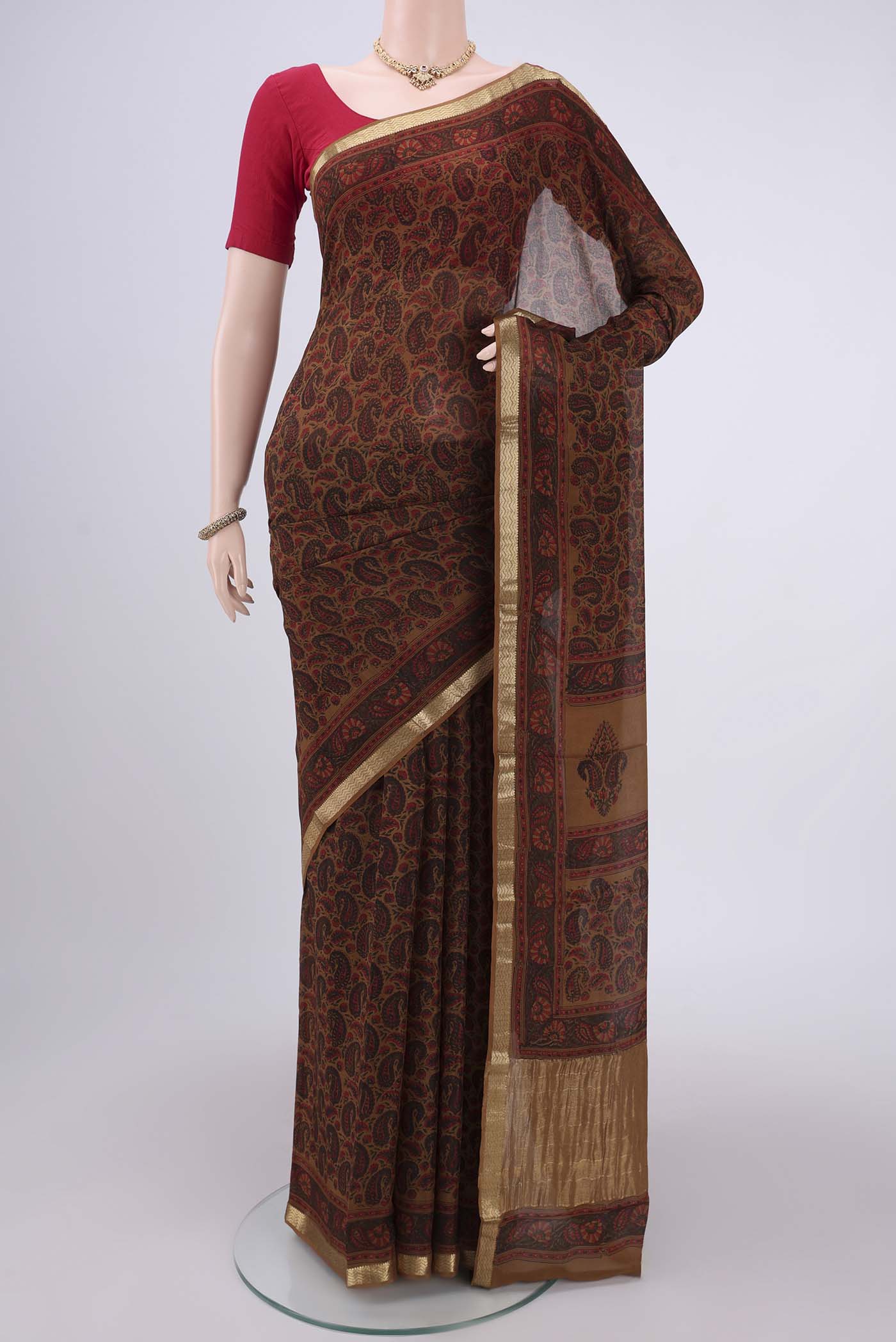 Brown Mysore Crepe Saree with Floral Print on the body and Zari Border.  displayed on a mannequin