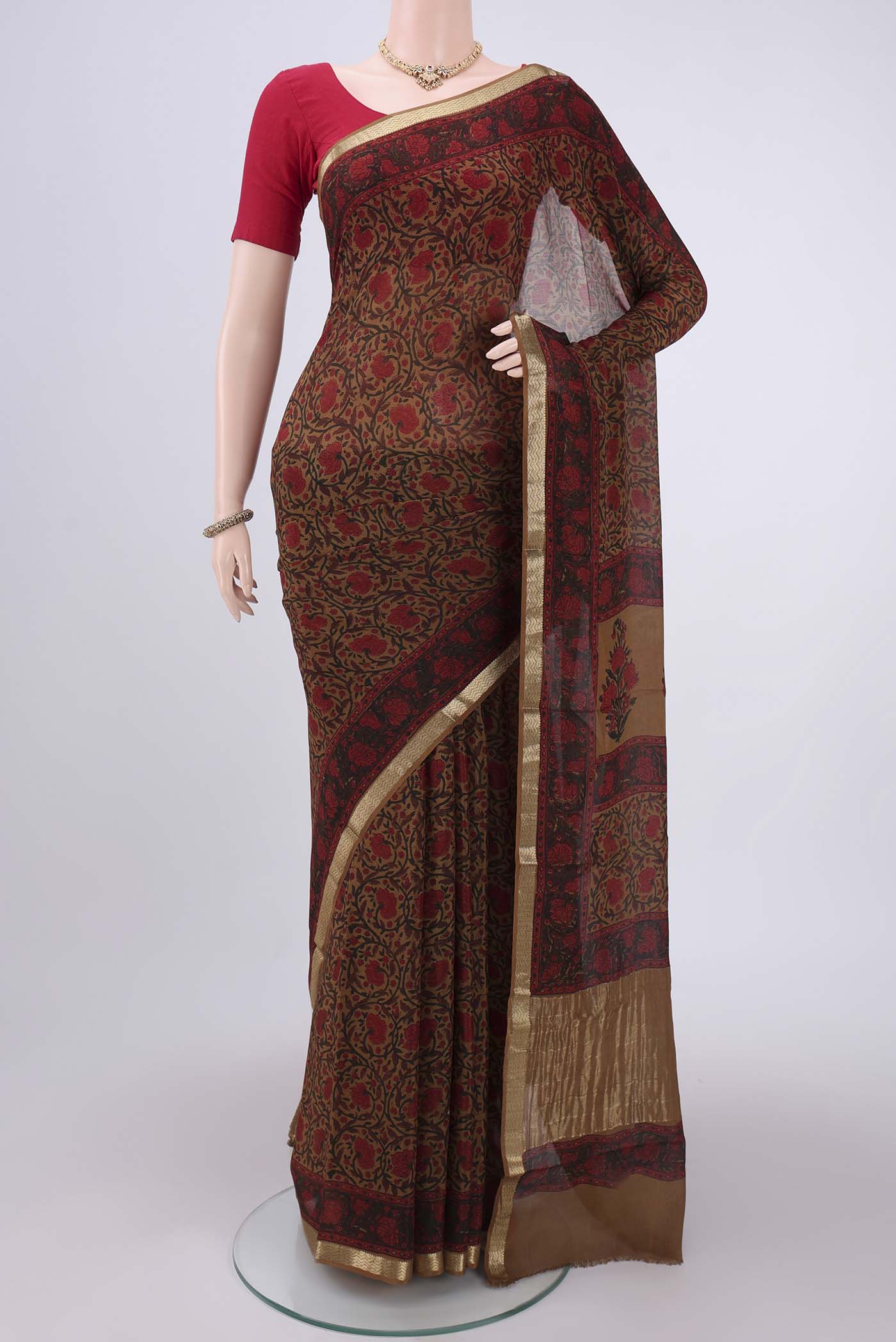 Mustard Mysore Crepe Saree with Floral Print on the body and Zari Border.  displayed on a mannequin
