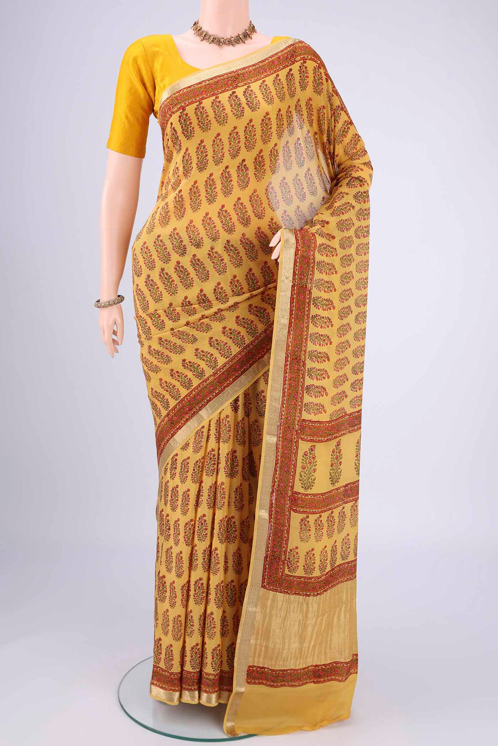 Yellow Mysore Crepe Saree with Floral Print on the body and Zari Border.  displayed on a mannequin