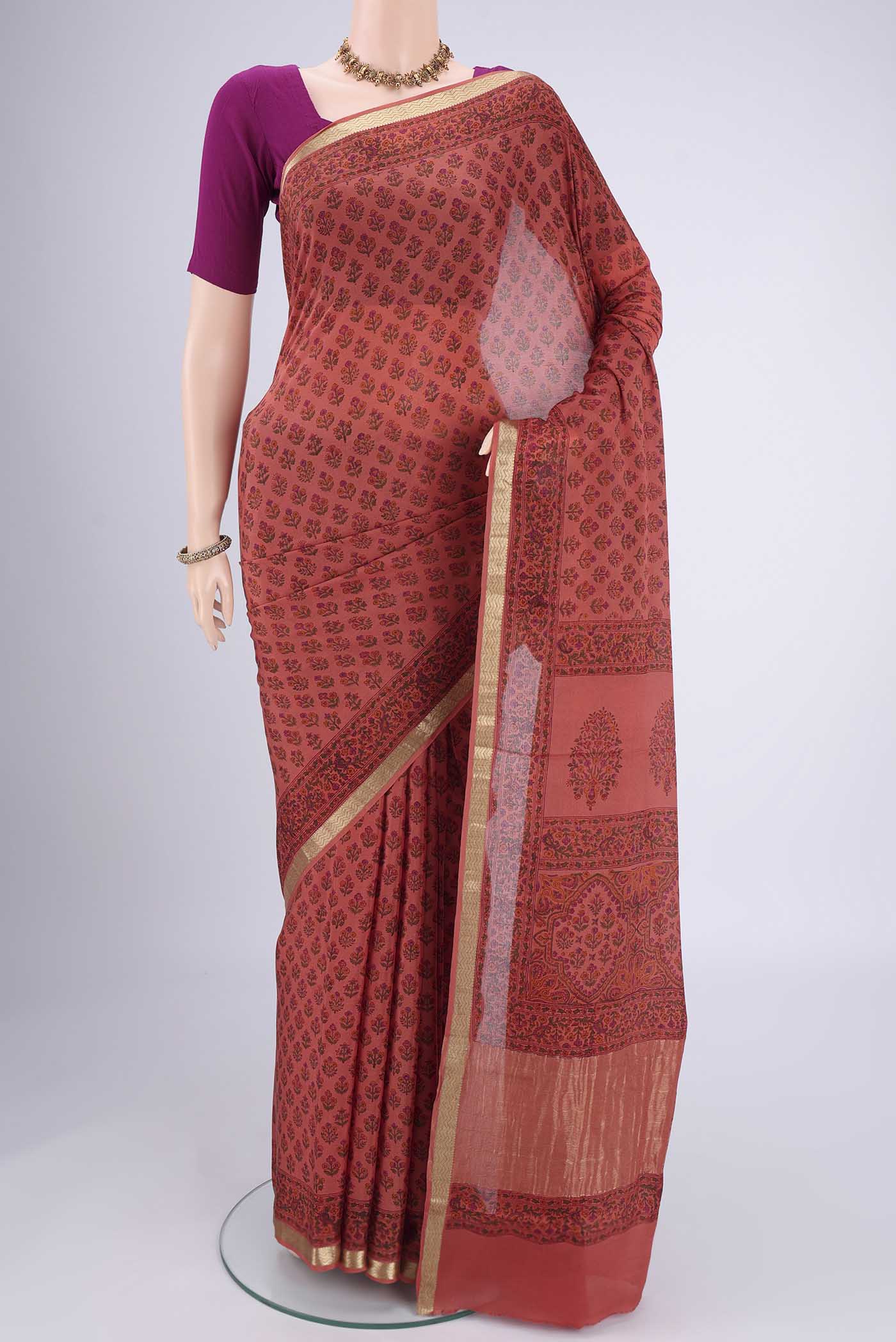 Coral Mysore Crepe Saree with Floral Print on the body and Zari Border.  displayed on a mannequin