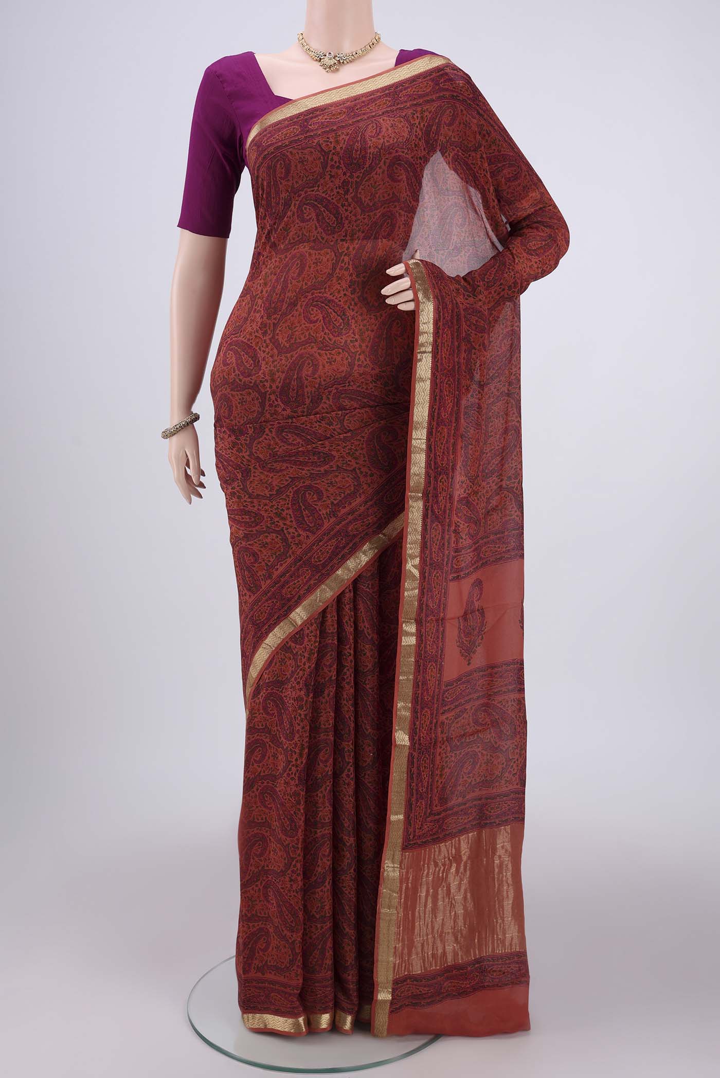 Peach Mysore Crepe Saree with Floral Print on the body and Zari Border.  displayed on a mannequin
