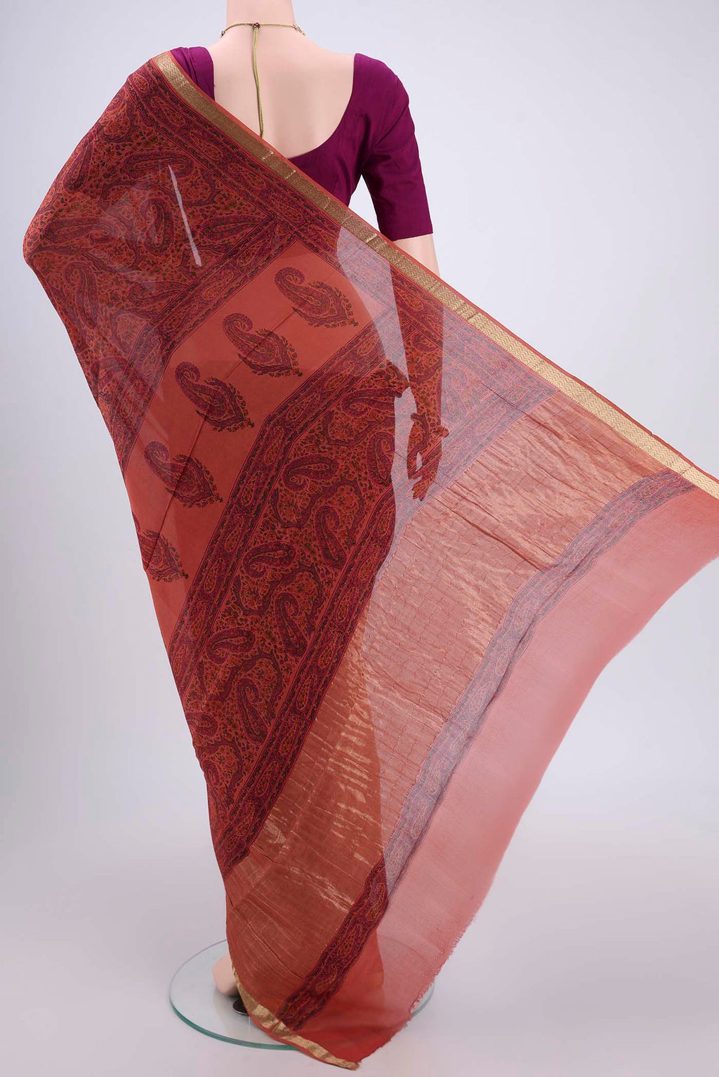 Flat view of Peach Mysore Crepe Saree with Floral Print on the body and Zari Border. 