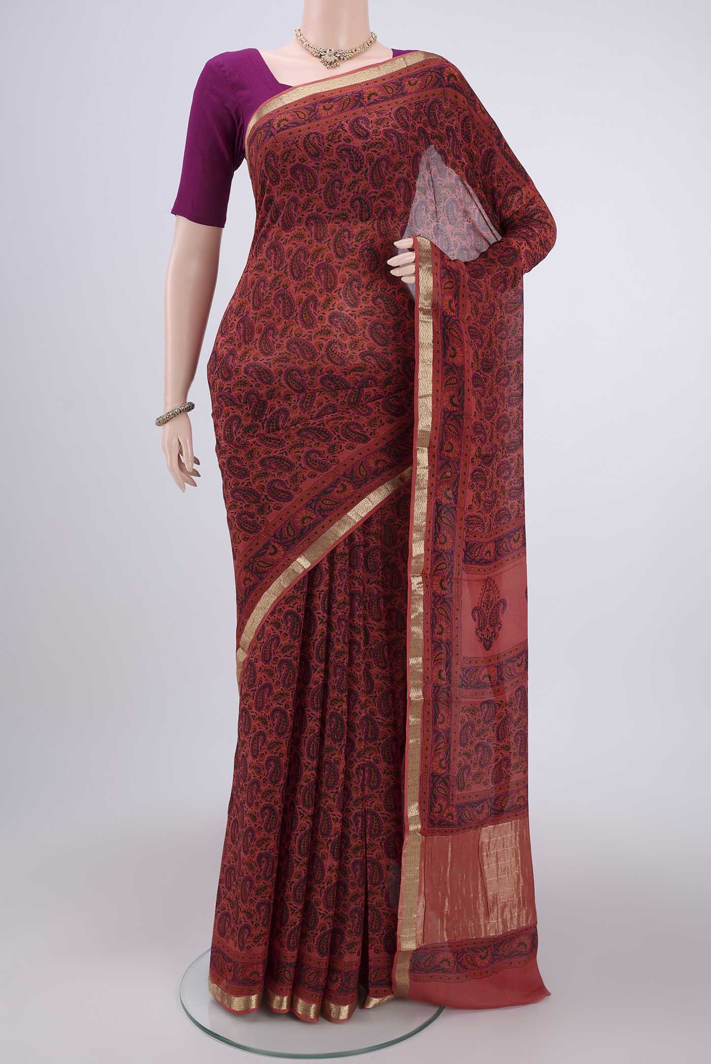 Peach Mysore Crepe Saree with Floral Print on the body and Zari Border.  displayed on a mannequin