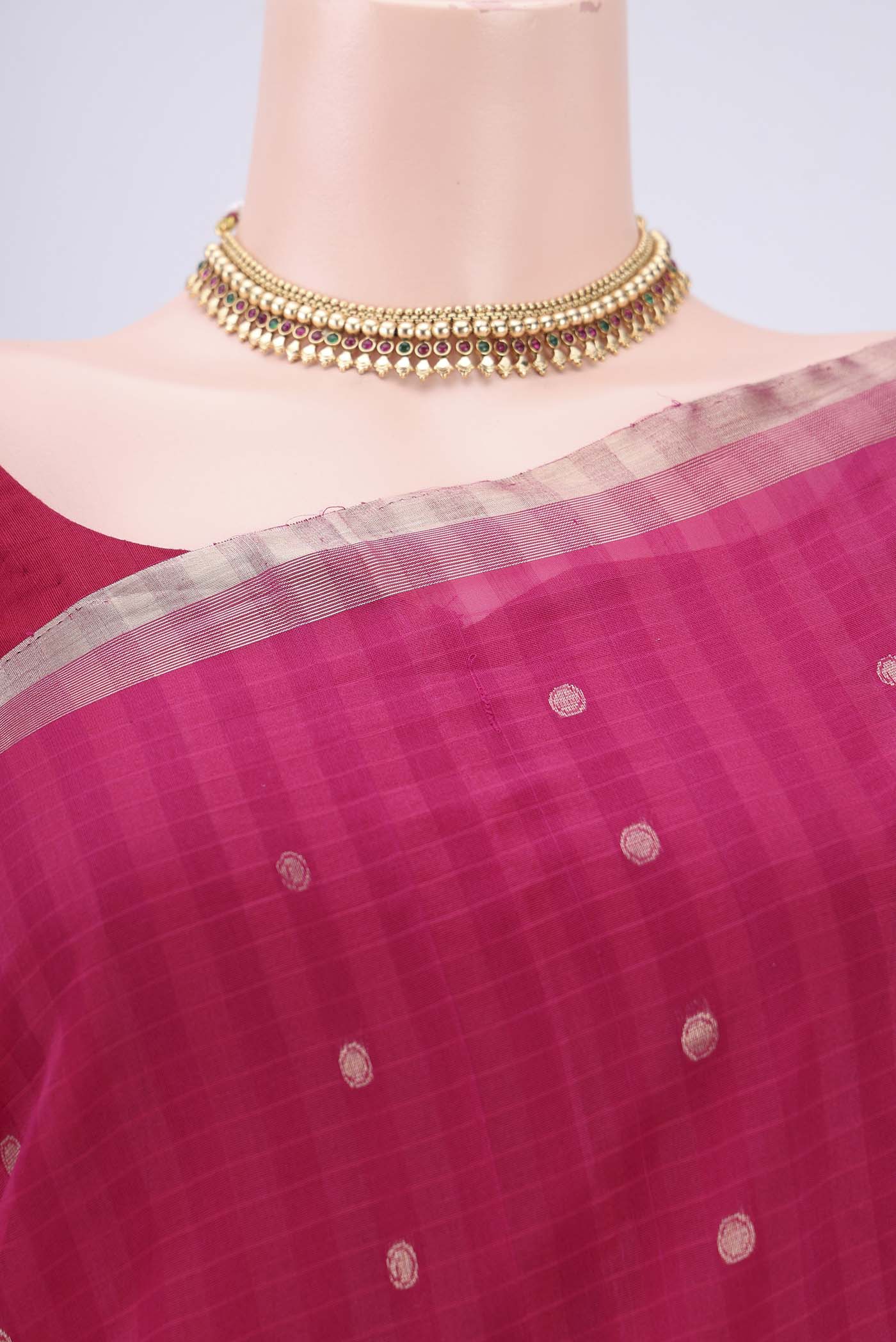 Border image of Rani Pink Silk Cotton Saree with Zari Butta on the body and Zari Border. 