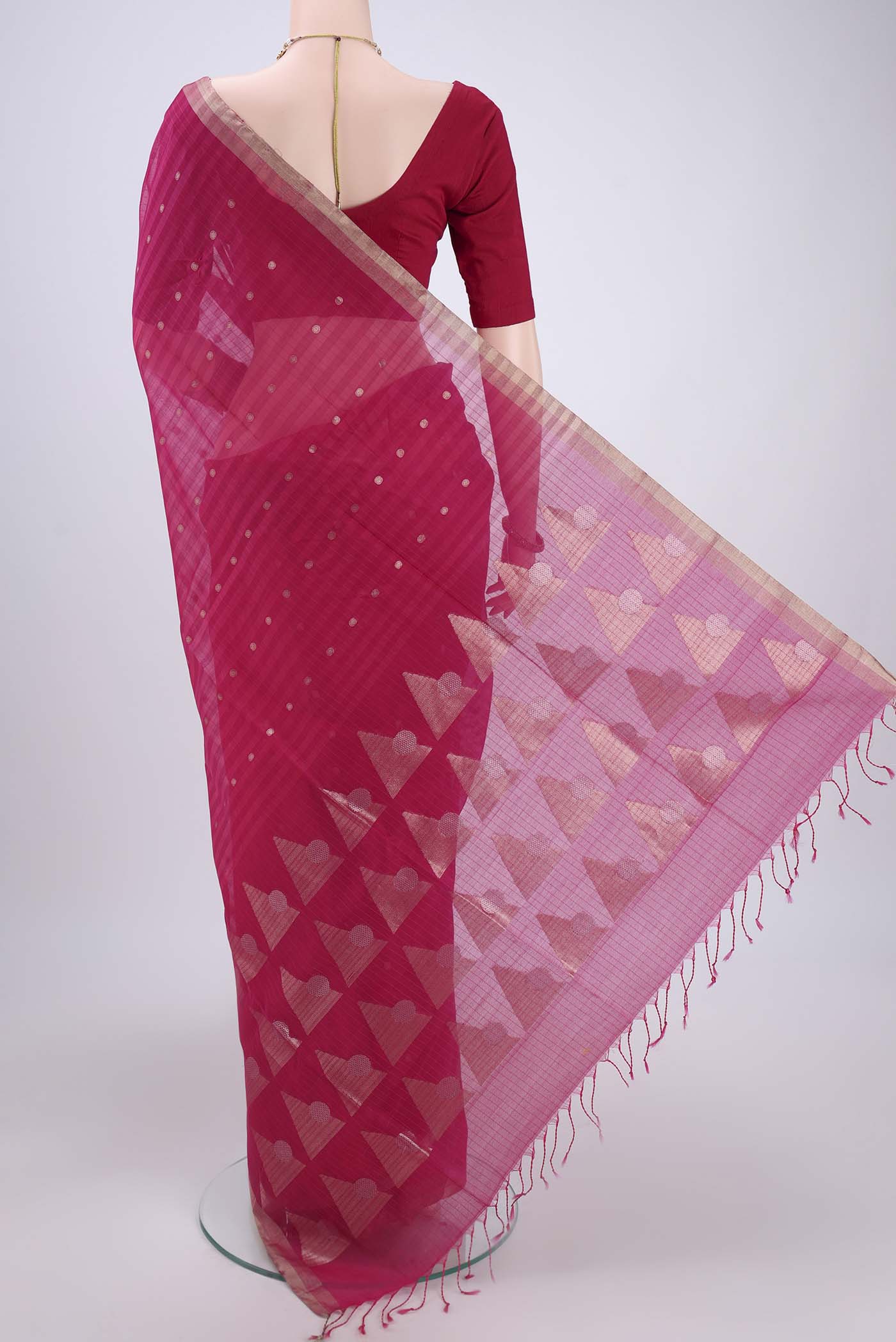 Flat view of Rani Pink Silk Cotton Saree with Zari Butta on the body and Zari Border. 