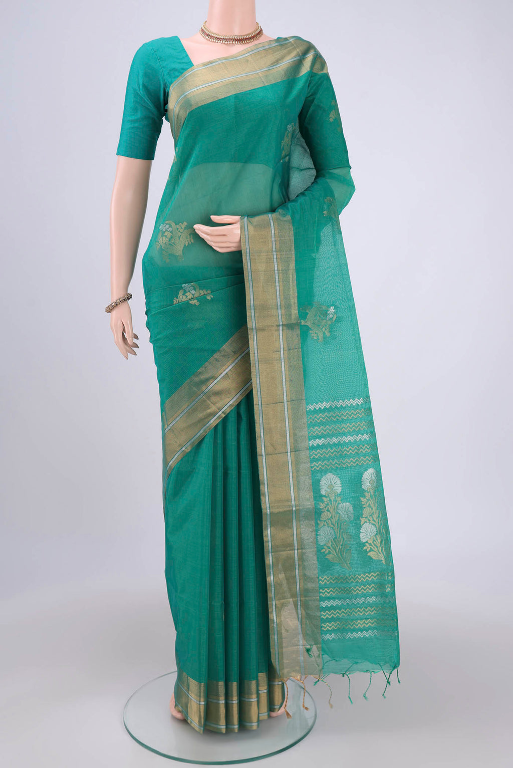 Sea Green Silk Cotton Saree with Zari Butta on the body and Zari Border.  displayed on a mannequin