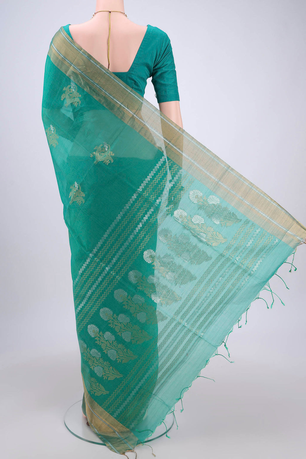 Flat view of Sea Green Silk Cotton Saree with Zari Butta on the body and Zari Border. 