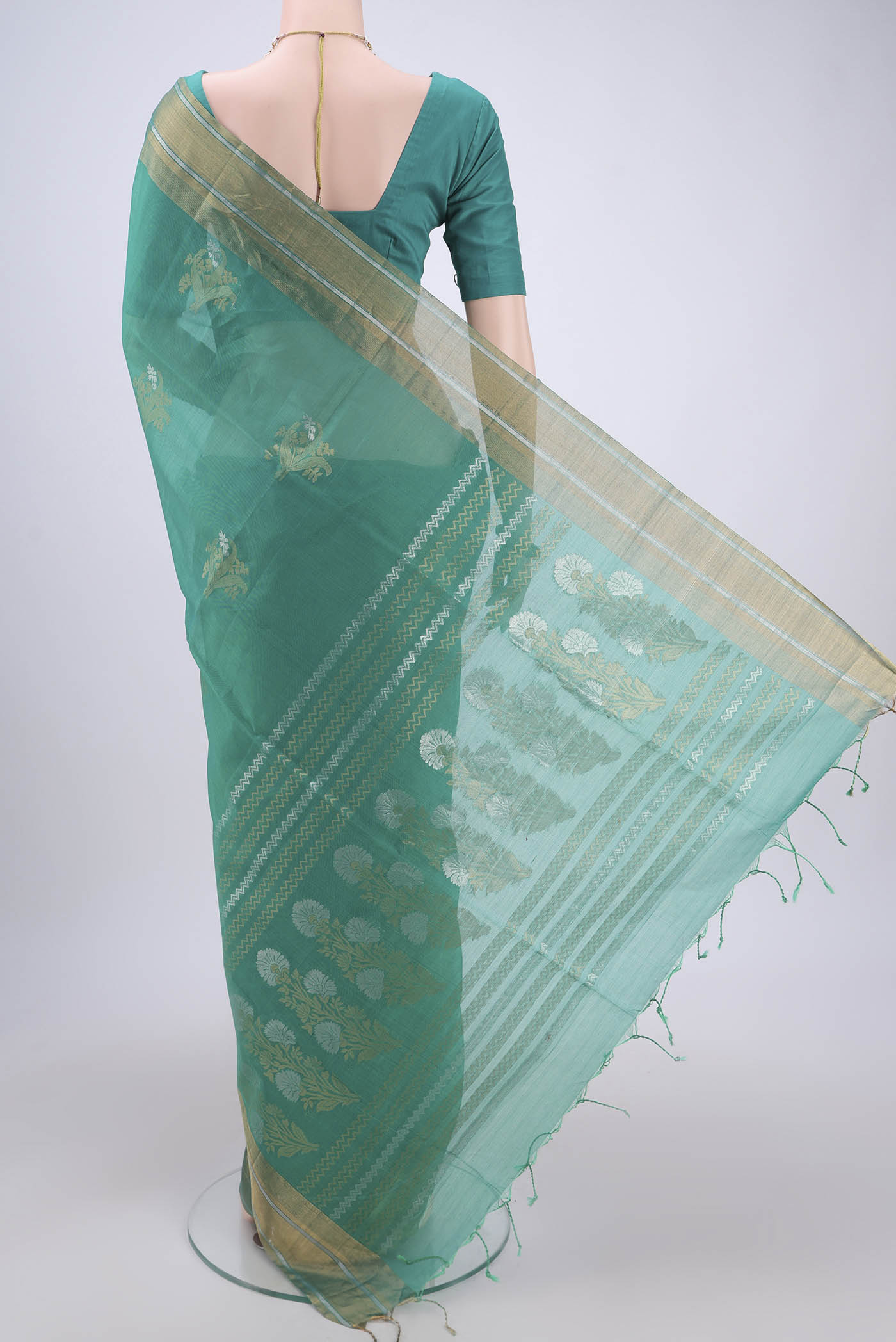 Flat view of Sea Green Silk Cotton Saree with Zari Butta on the body and Zari Border. 