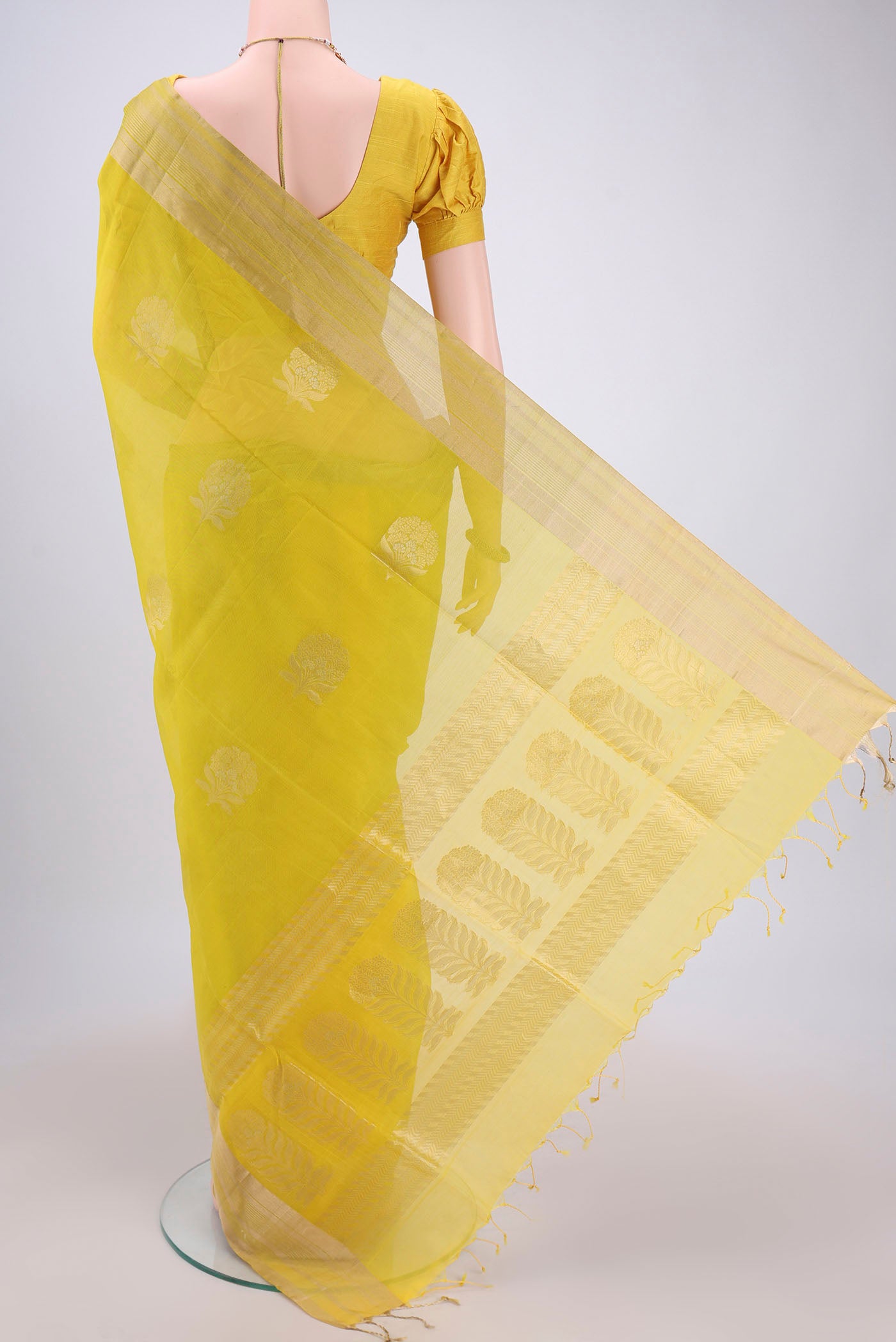 Flat view of Lemon Yellow Silk Cotton Saree with Zari Butta on the body and Zari Border. 
