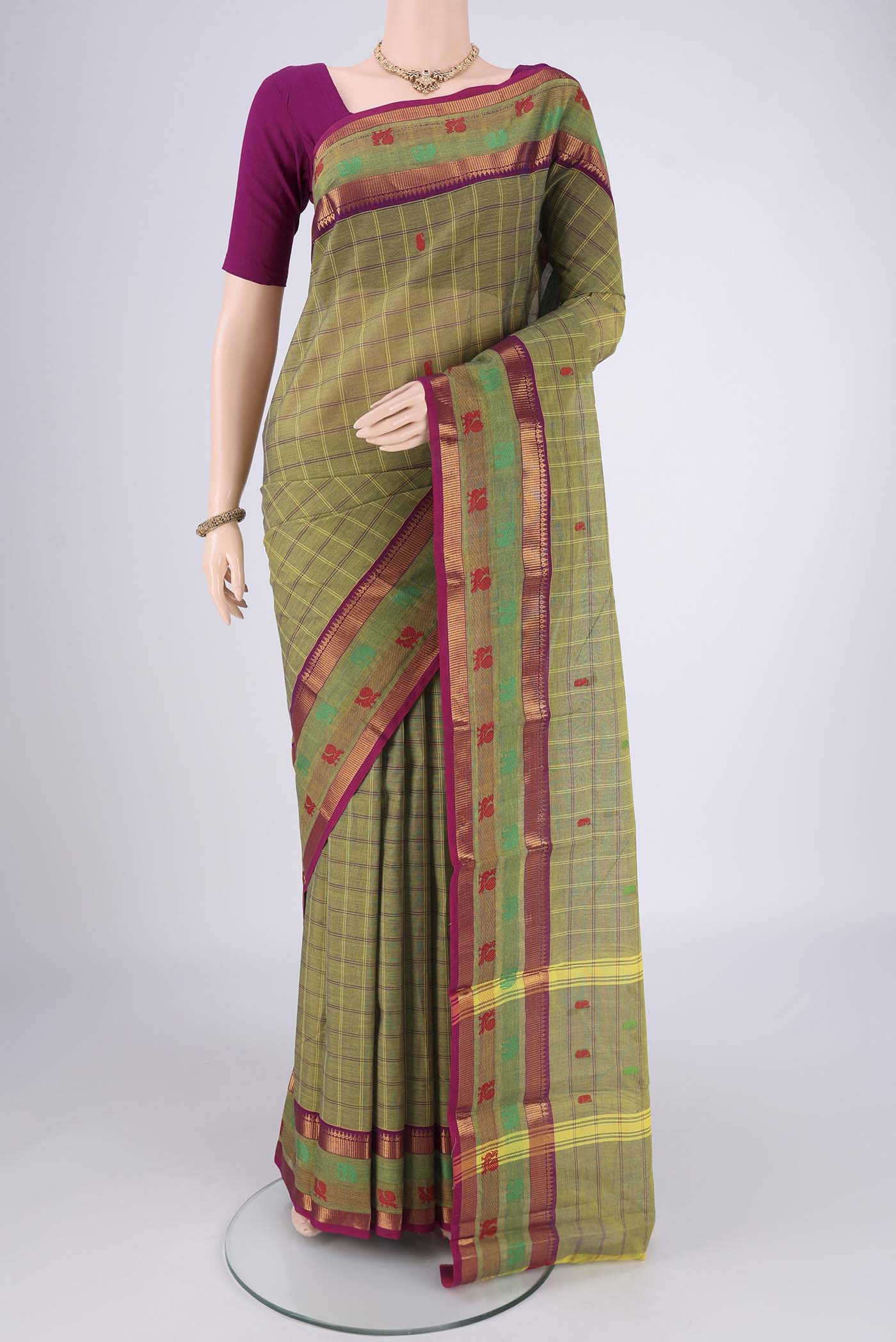 Mehandi Green Kanchi Cotton Saree with Checked design on the body and Temple Border.  displayed on a mannequin