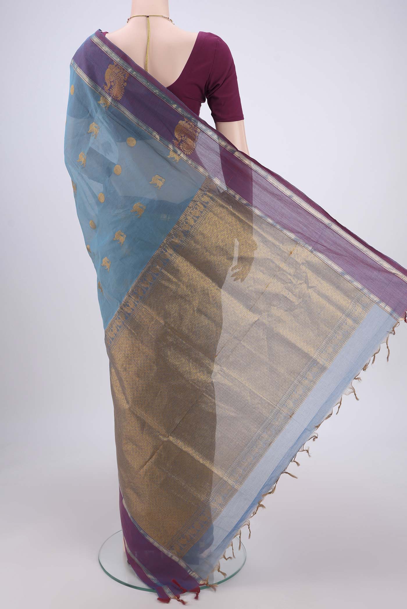 Flat view of Light Blue Coimbatore Cotton Saree with Zari Butta on the body and Zari Border. 