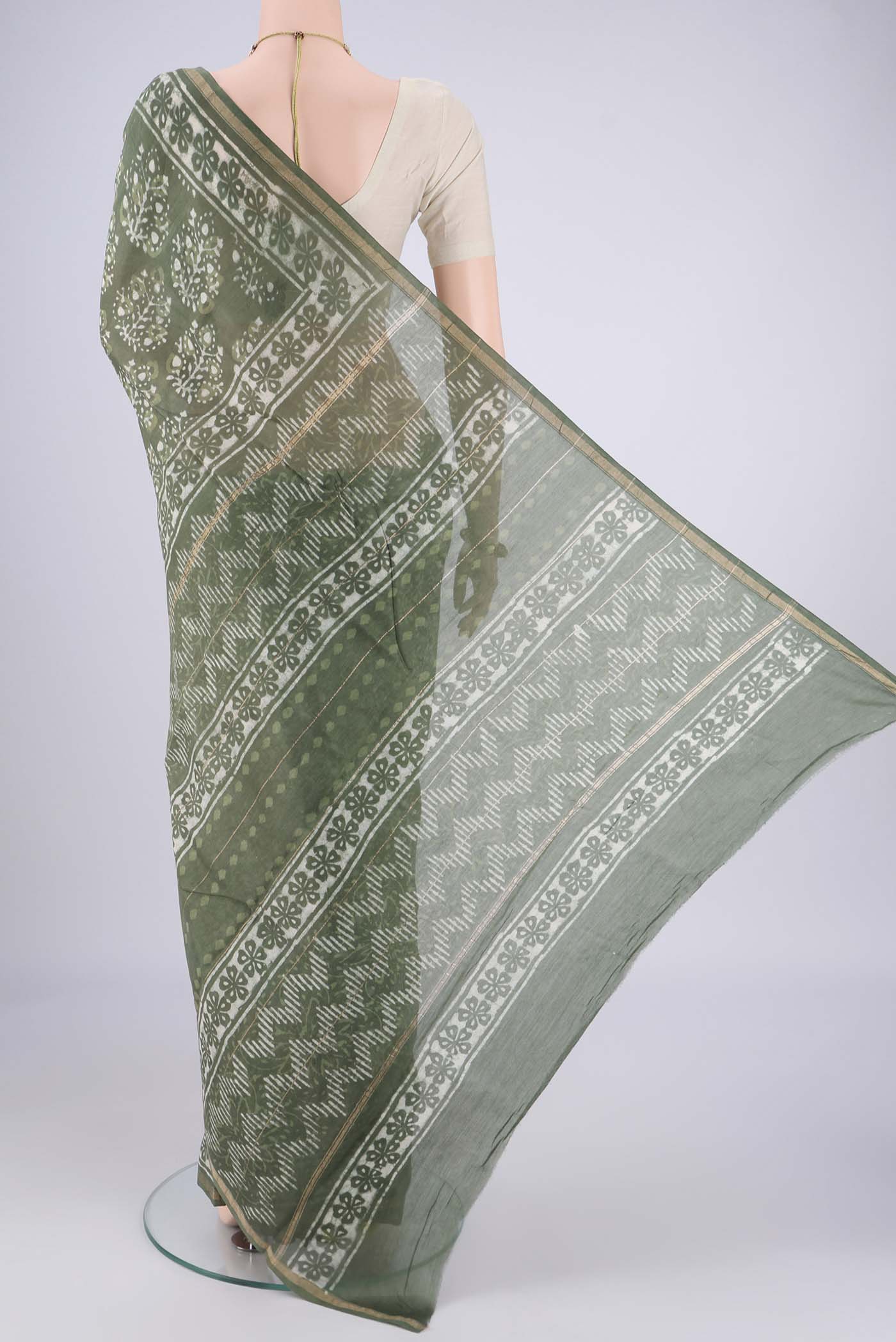 Flat view of Sea Green Maheshwari Silk Cotton Saree with Batik Print on the body and Zari Border. 