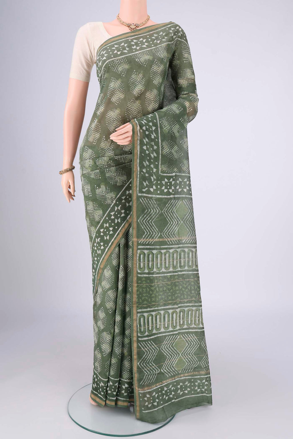 Mehandi Green Maheshwari Silk Cotton Saree with Batik Print on the body and Zari Border.  displayed on a mannequin