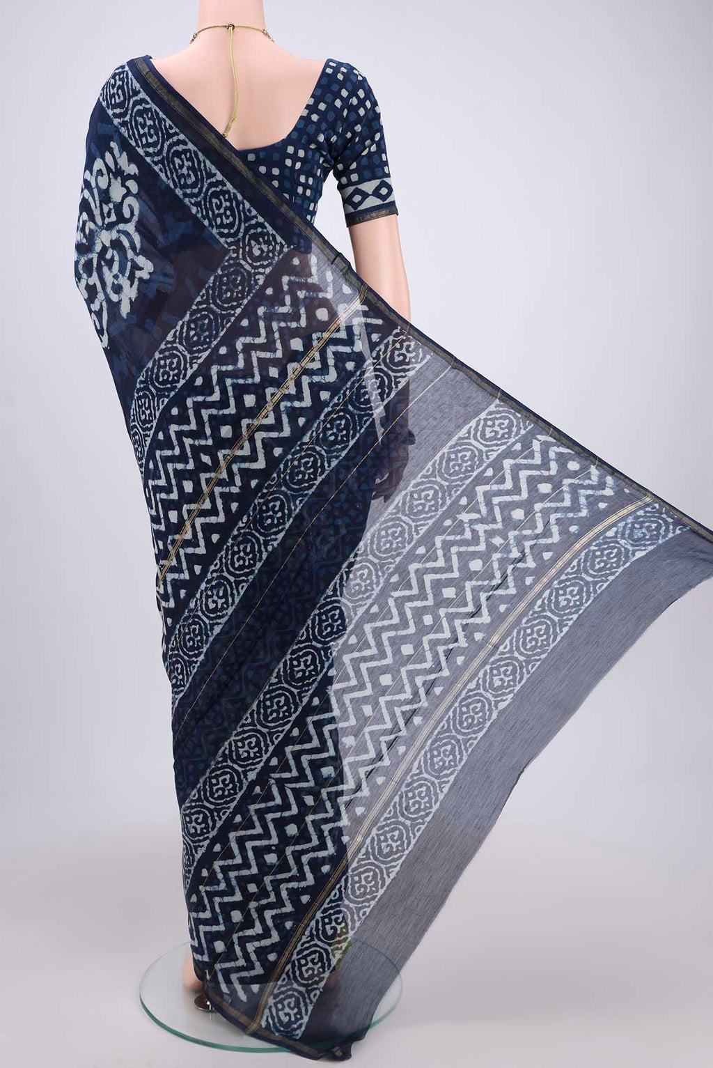 Flat view of Indigo Chanderi Silk Saree with Batik Print on the body and Zari Border. 
